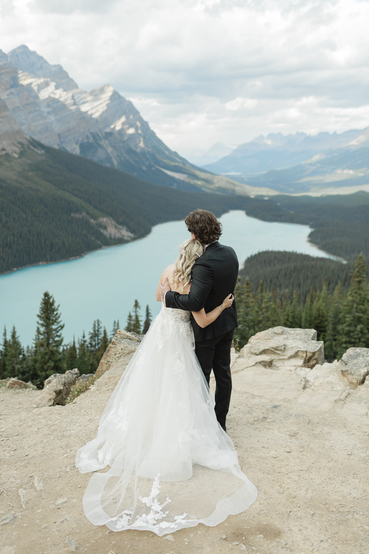 A couple embracing and looking in opposite directions after their wedding 