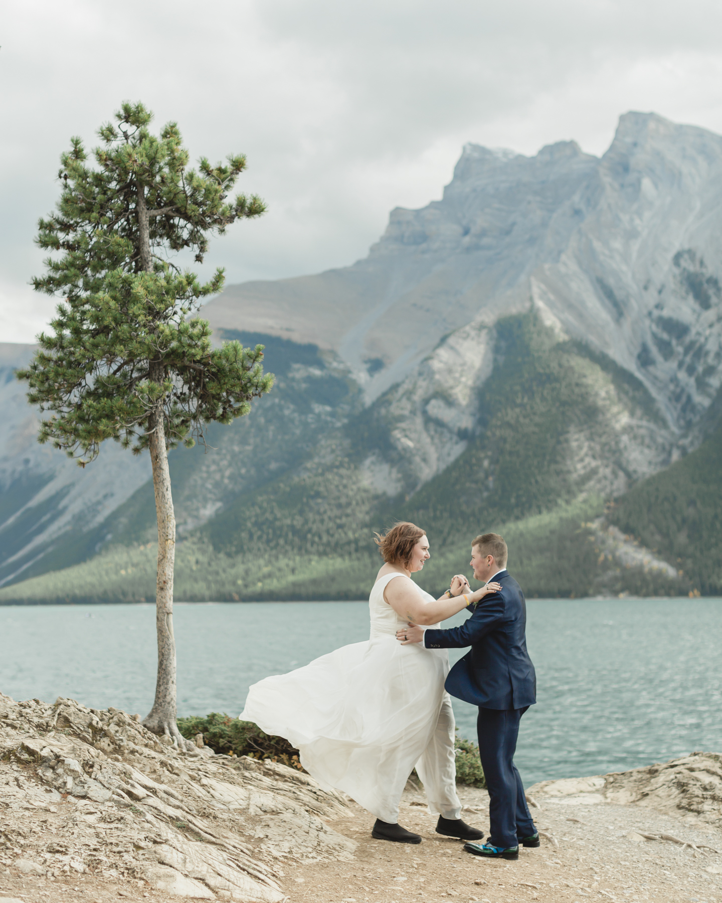 A LGBTQIA+ having their first dance after their elopement at Lake Minnewanka 