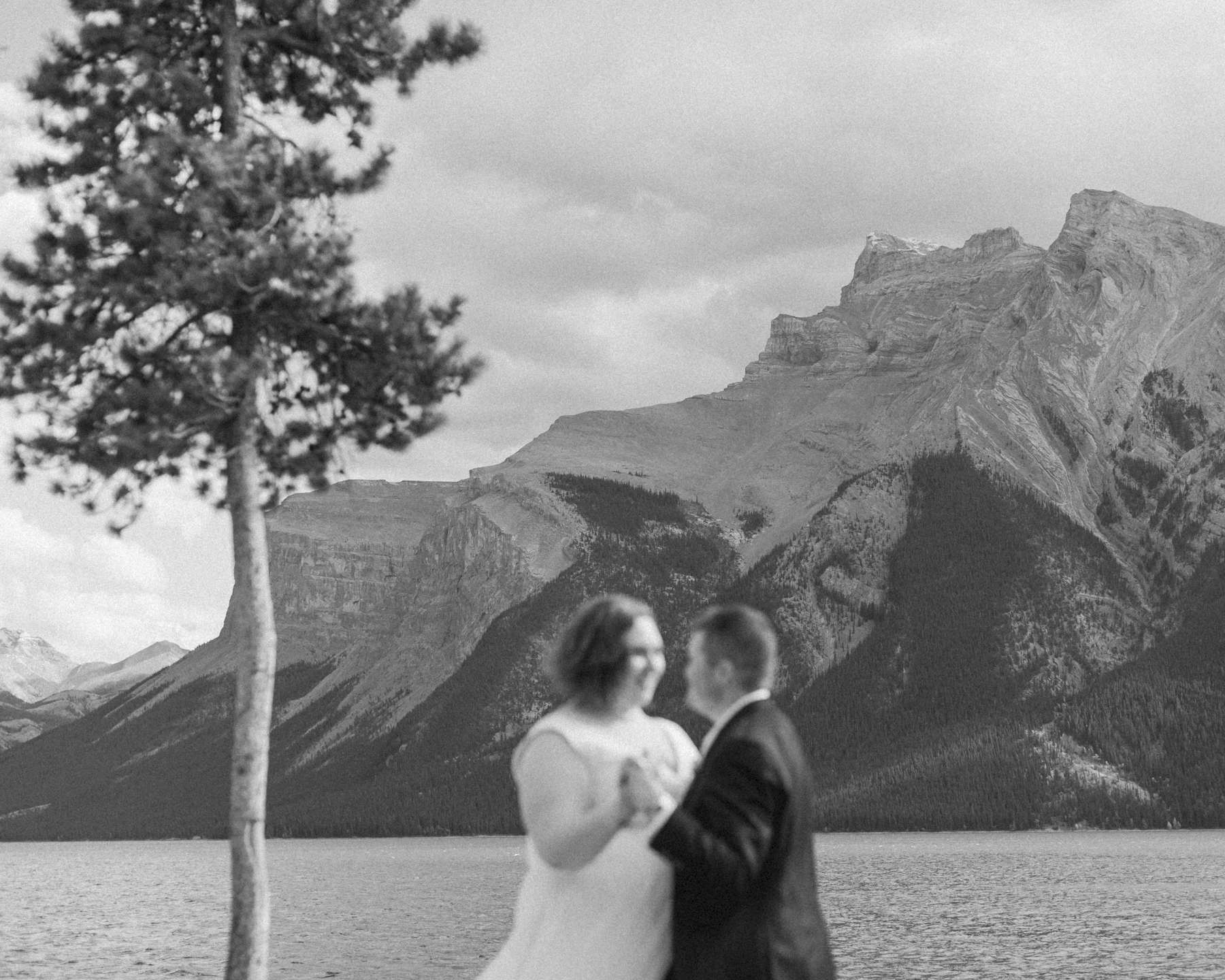 A LGBTQIA+ enjoying a picnic together after their elopement at Lake Minnewanka 