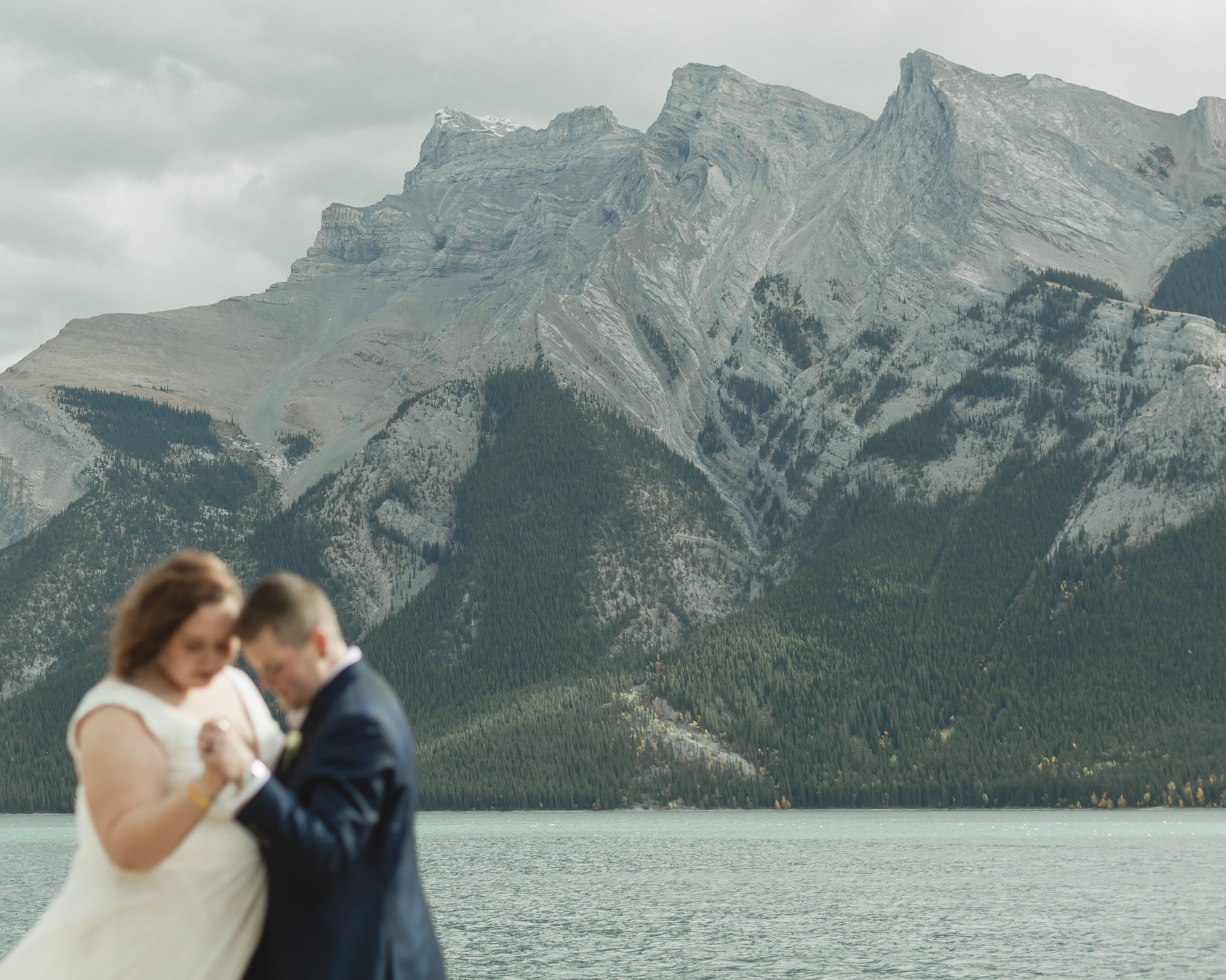 A LGBTQIA+ having their first dance after their elopement at Lake Minnewanka 