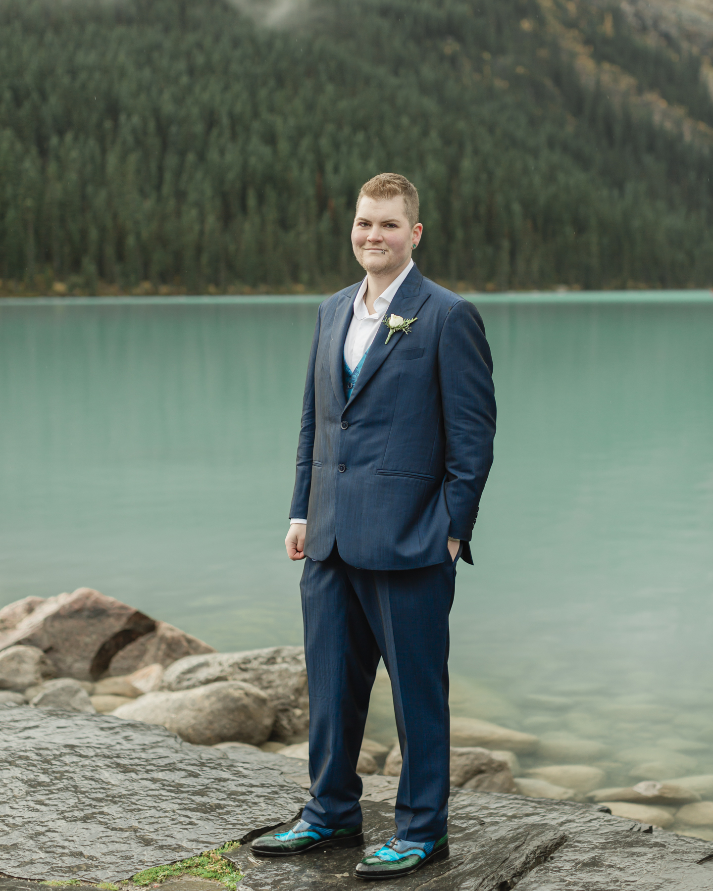 A portrait of a transmasc nonbinary person that just got married at Lake Louise