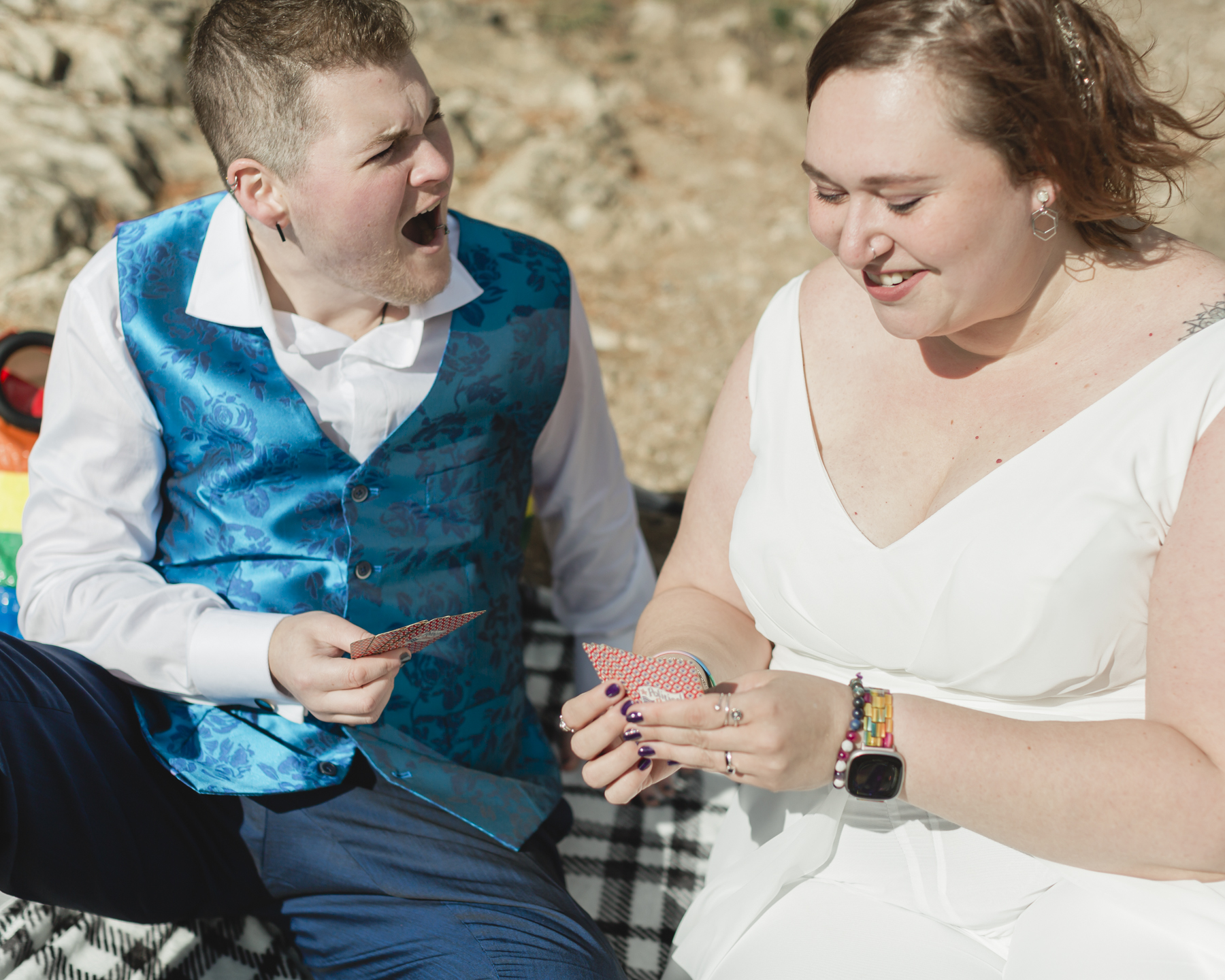 A LGBTQIA+ enjoying a picnic together after their elopement at Lake Minnewanka 