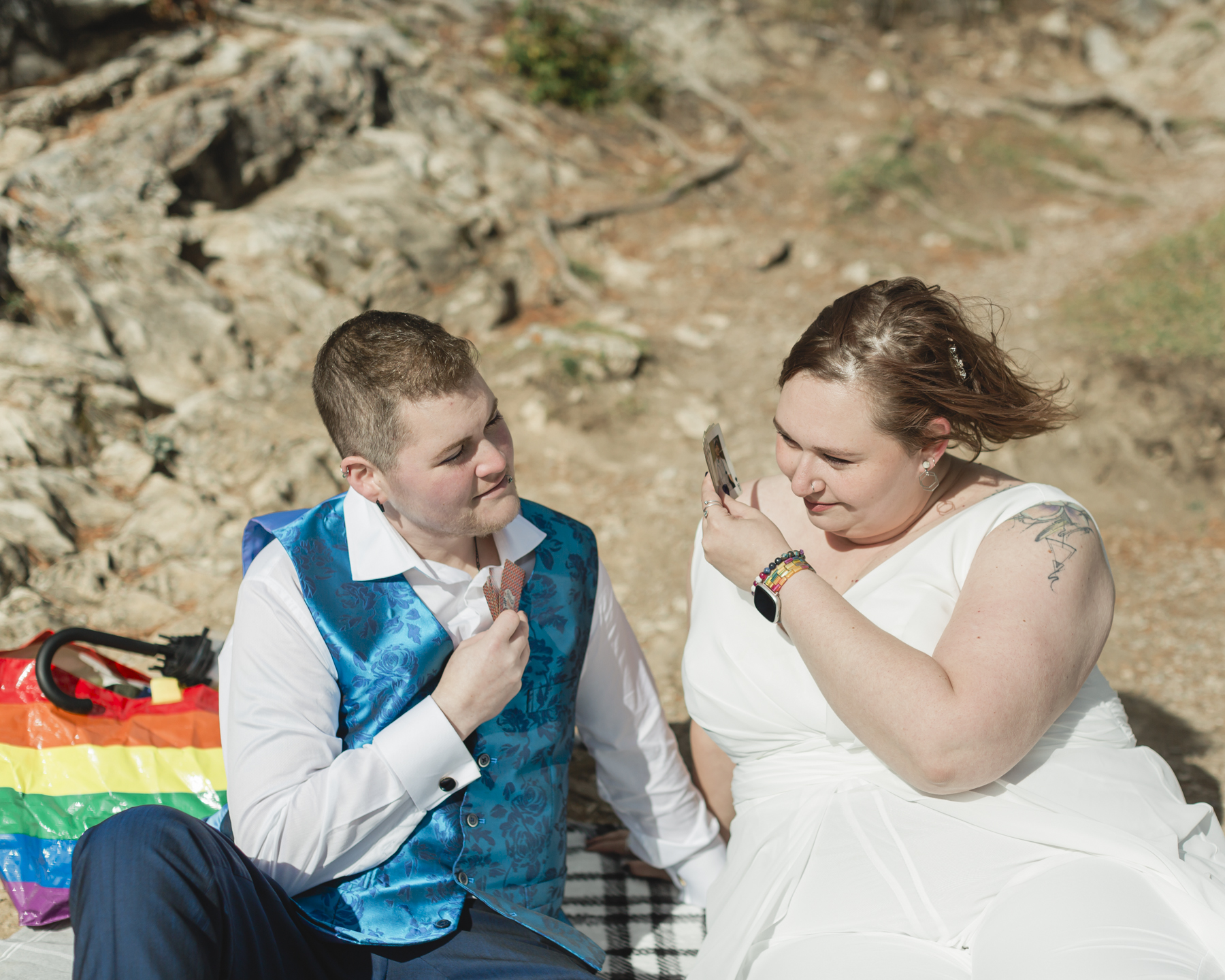 A LGBTQIA+ enjoying a picnic together after their elopement at Lake Minnewanka 