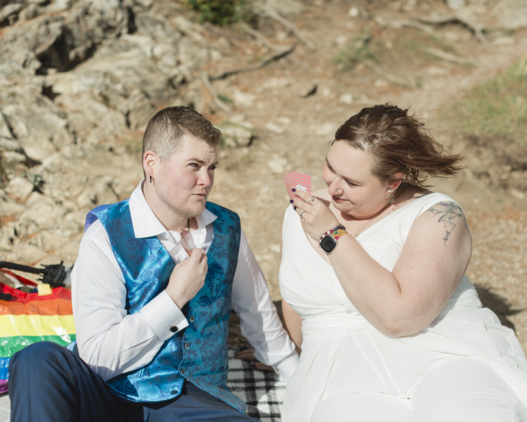 A LGBTQIA+ enjoying a picnic together after their elopement at Lake Minnewanka 