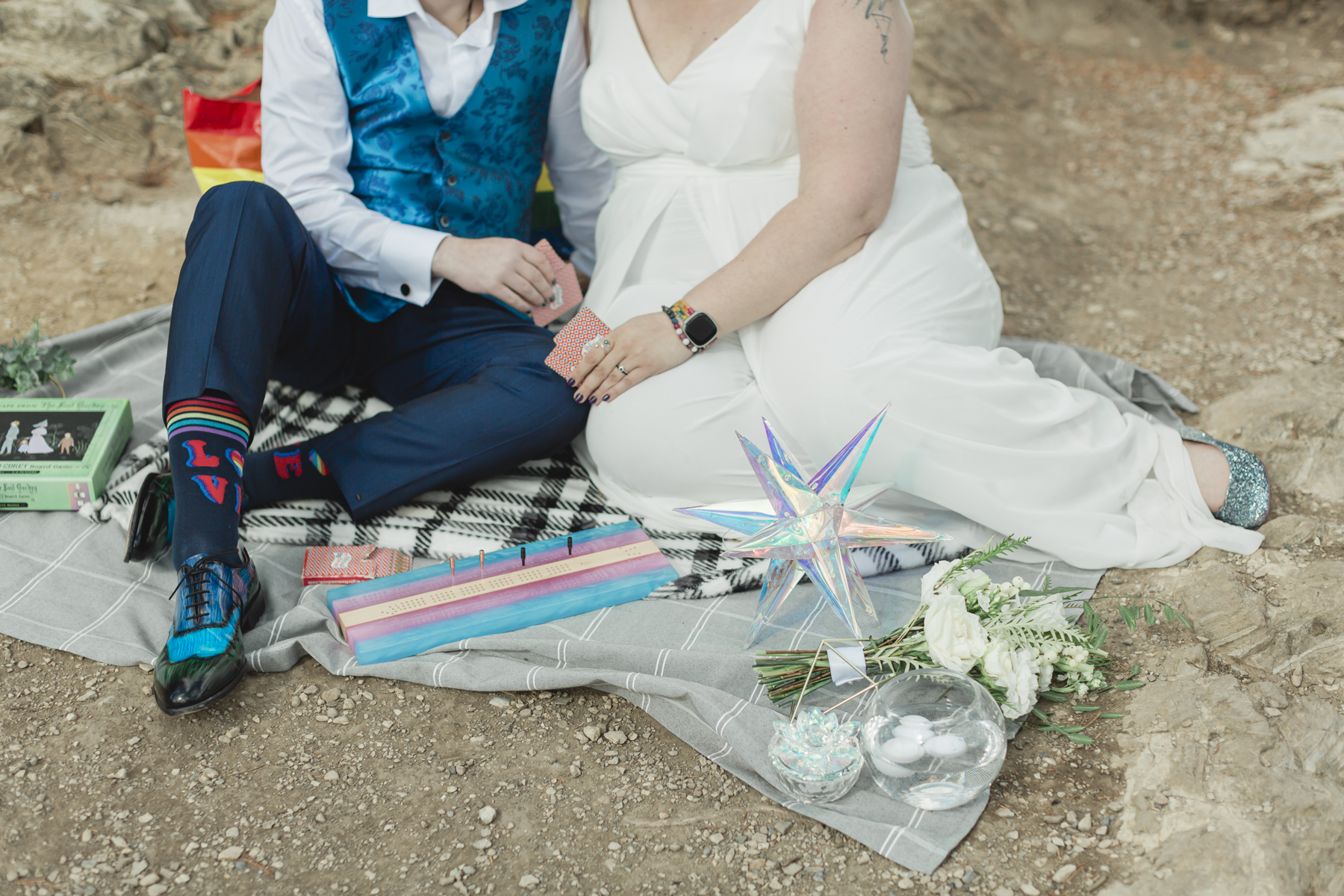 A LGBTQIA+ enjoying a picnic together after their elopement at Lake Minnewanka 