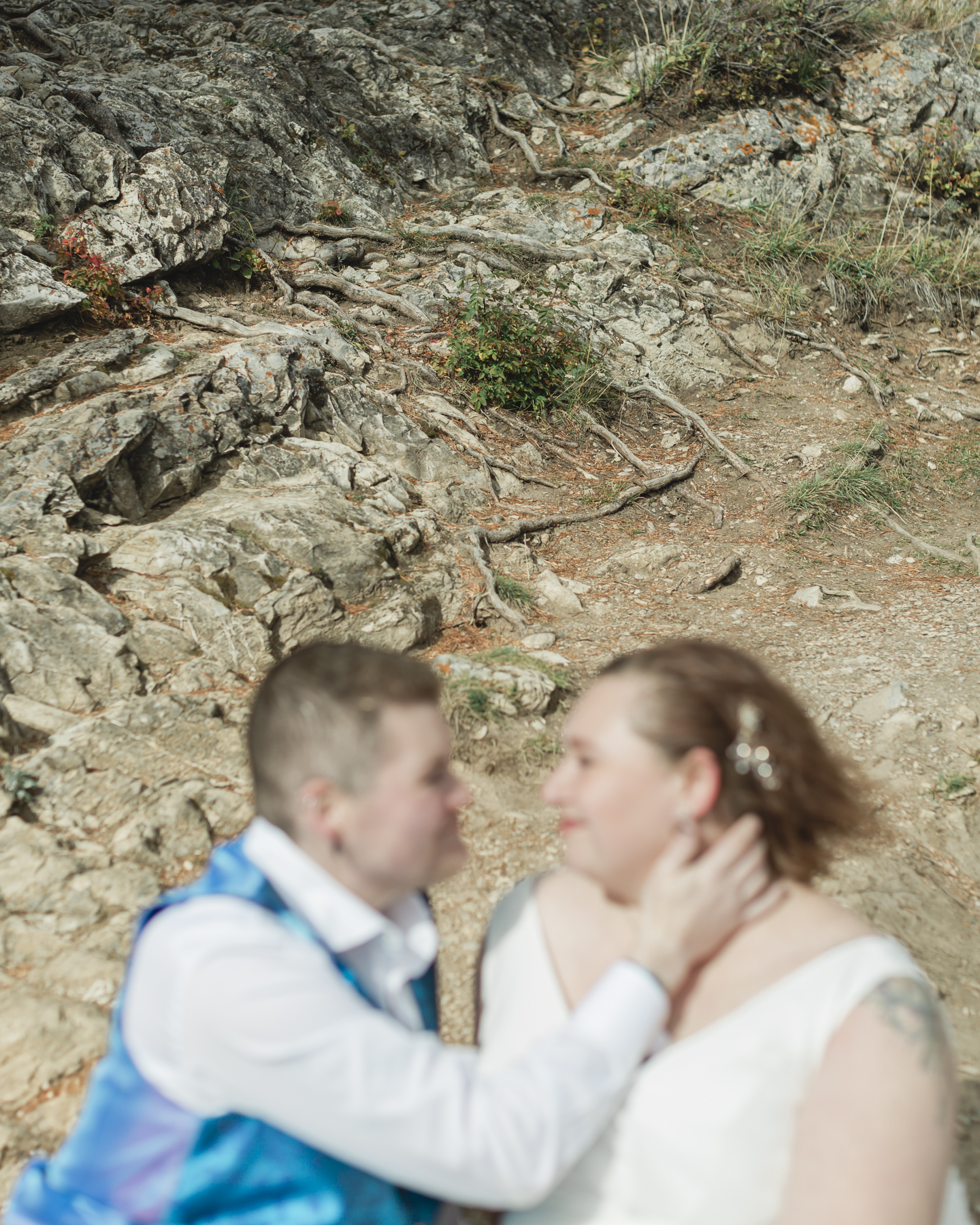 A LGBTQIA+ enjoying a picnic together after their elopement at Lake Minnewanka 