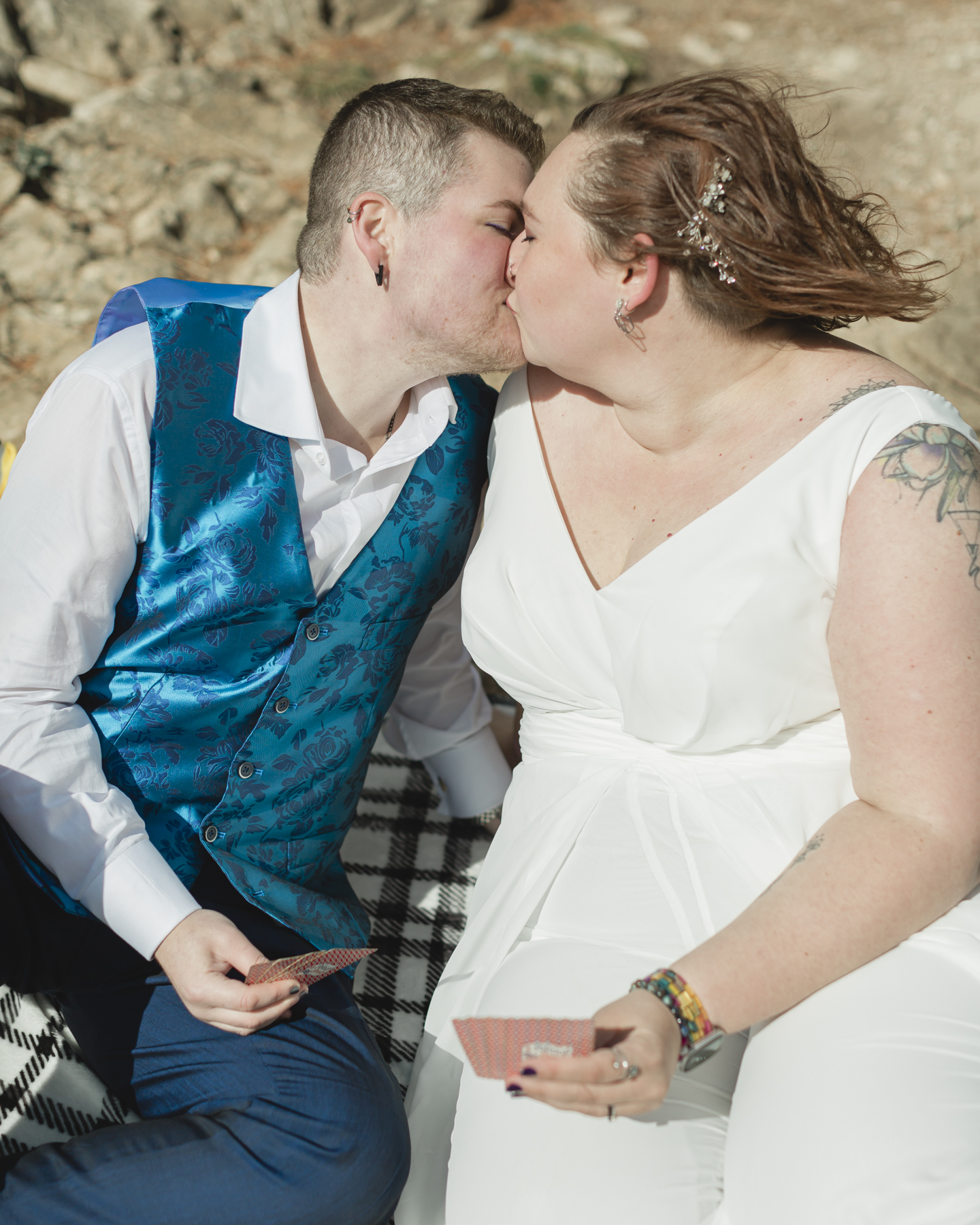 A LGBTQIA+ enjoying a picnic together after their elopement at Lake Minnewanka 