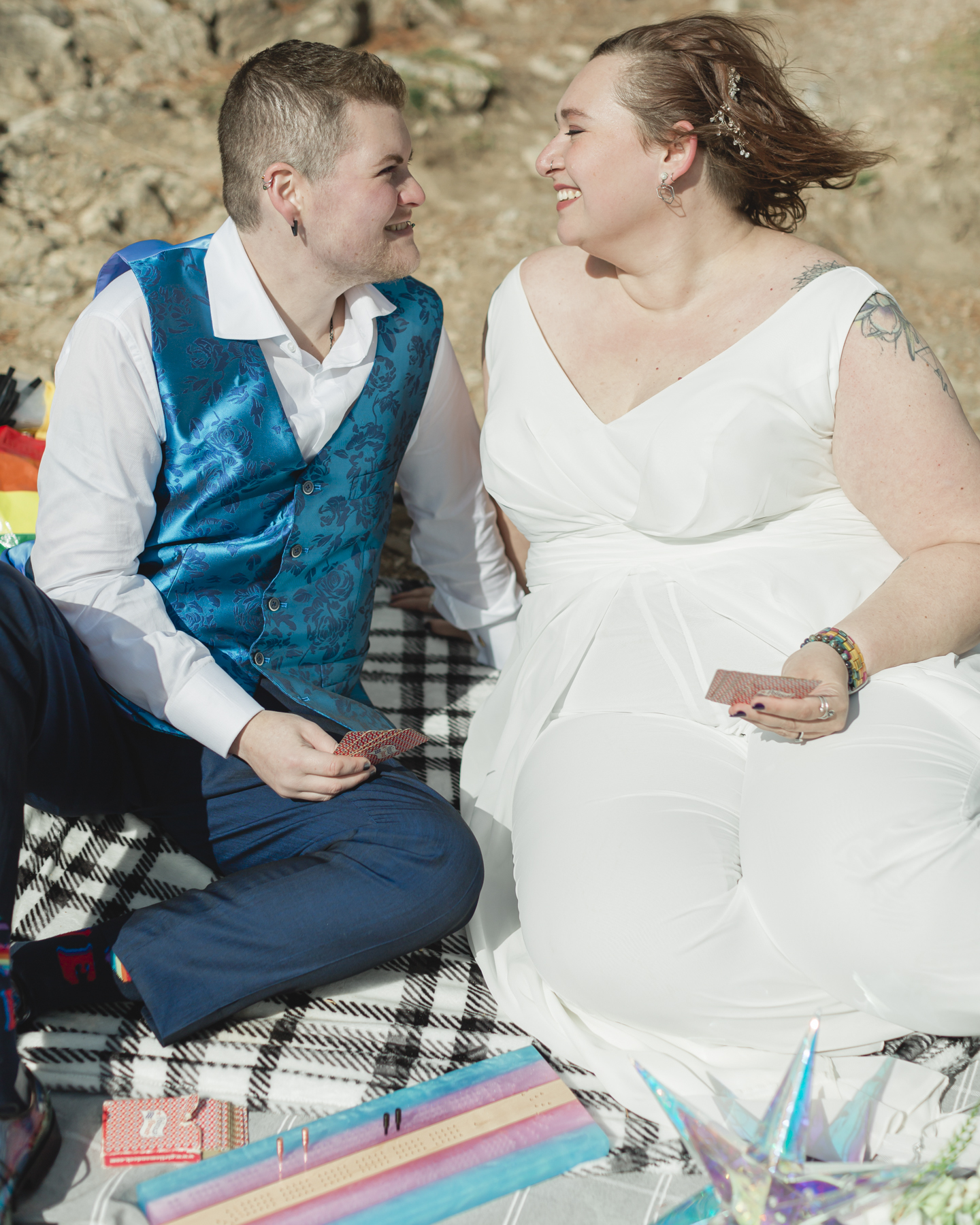 A LGBTQIA+ enjoying a picnic together after their elopement at Lake Minnewanka 