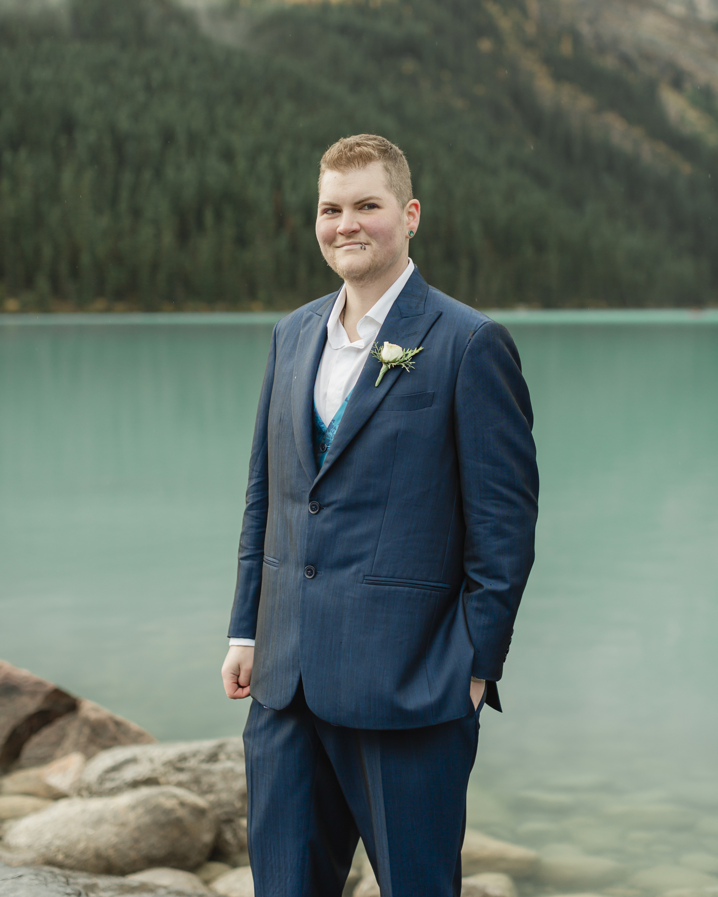 A portrait of a transmasc nonbinary person that just got married at Lake Louise