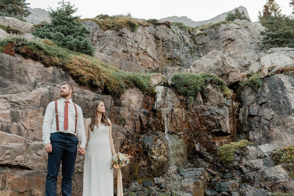 Emily & Jon pose on a cliffside for the Nordegg elopement