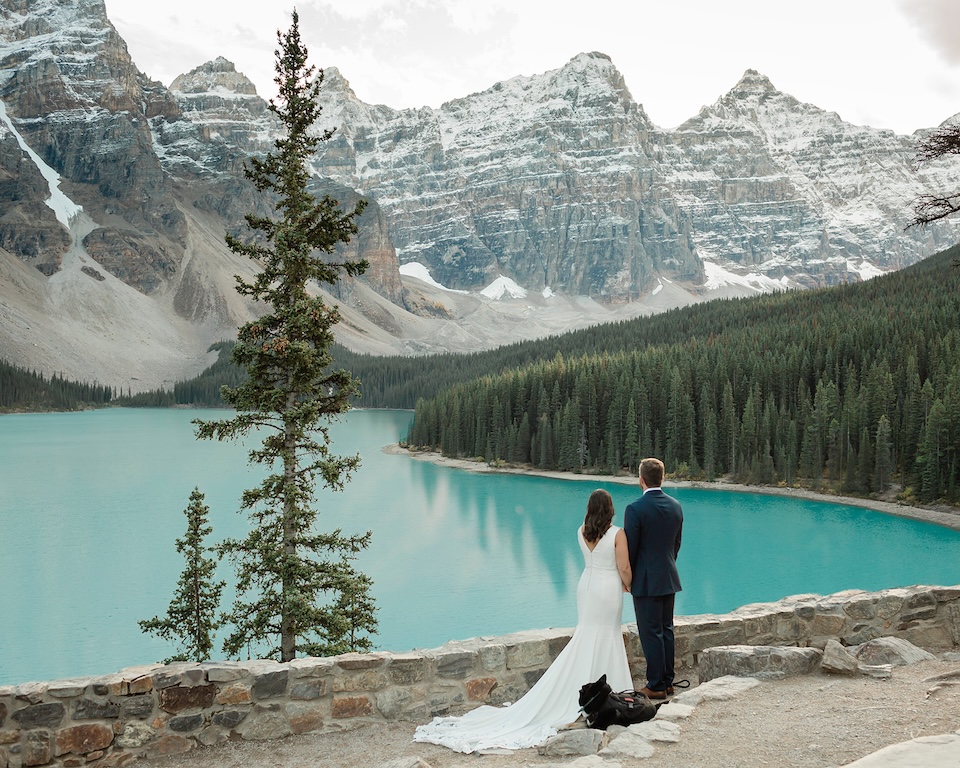 Erin, Regan & their puppy look out over Moraine Lake on their elopement