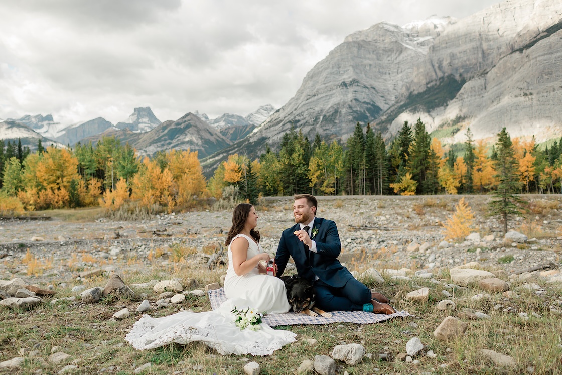 Erin & Reagan enjoy a Ritz cracker picnic with their dog during their Kananaskis elopement