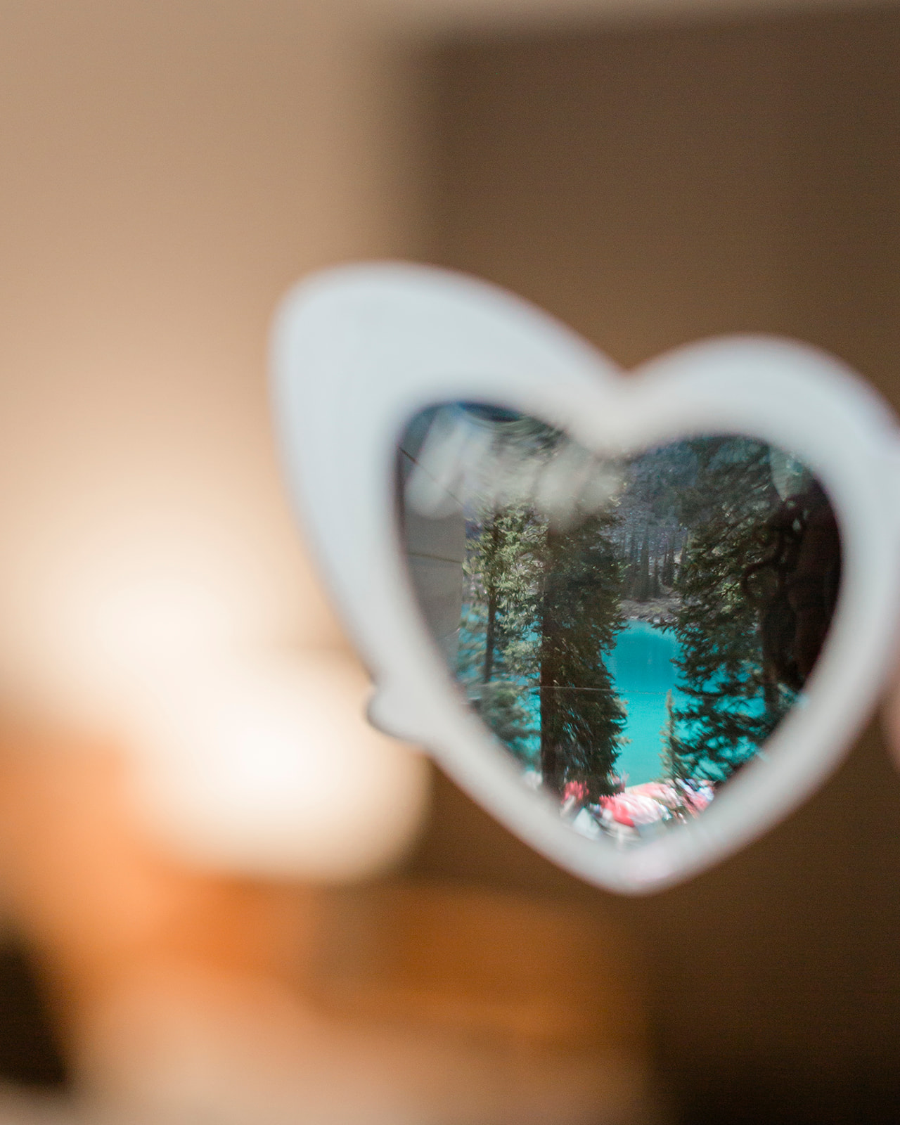 Moraine lake viewed through the lens of a heart shaped lens of a pair of sunglasses