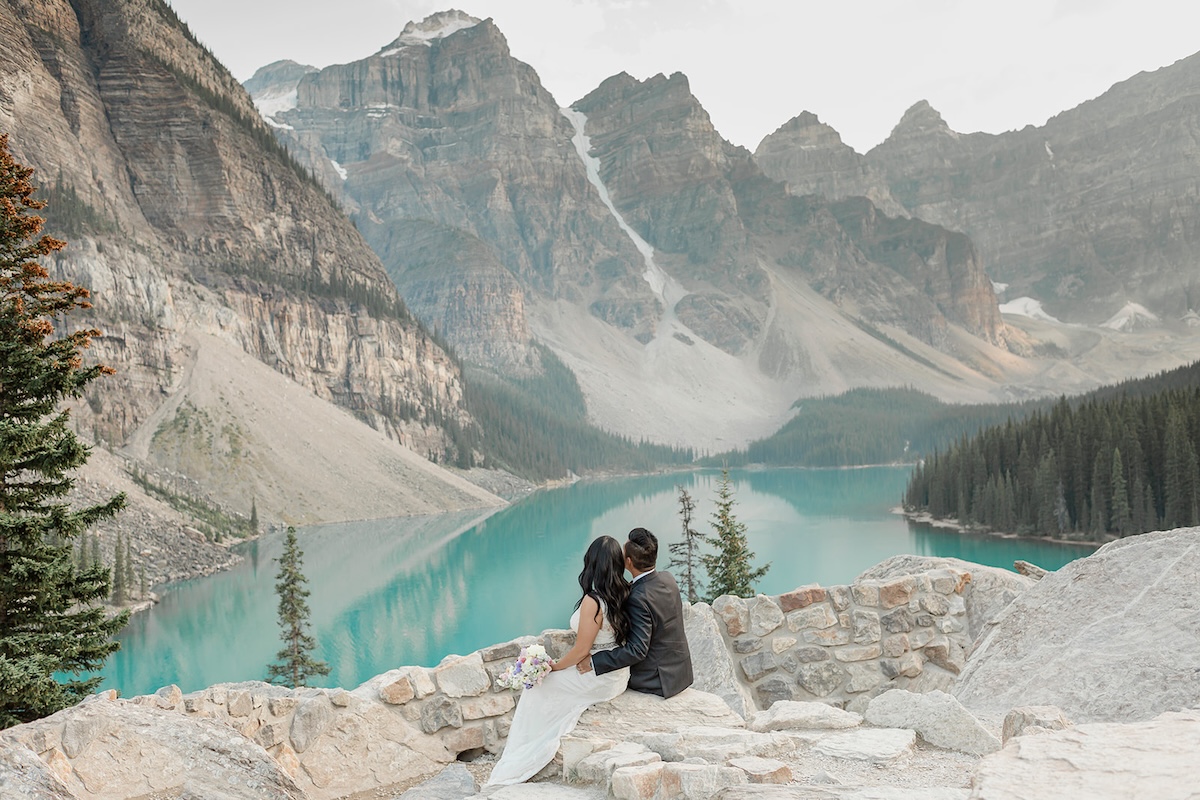 sunny and kitty look out over Moraine Lake during their elopement in Banff