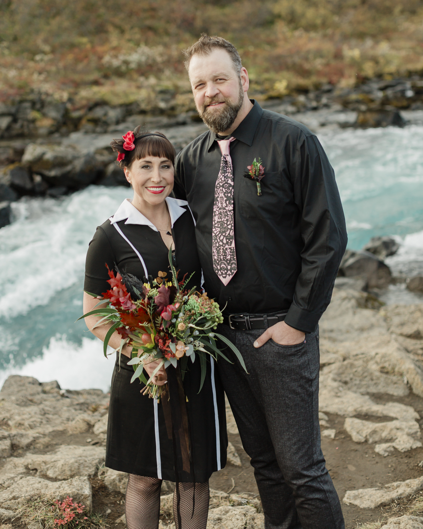 Elopement couple's portraits in front of a running waterfall in Iceland on the Golden Circle