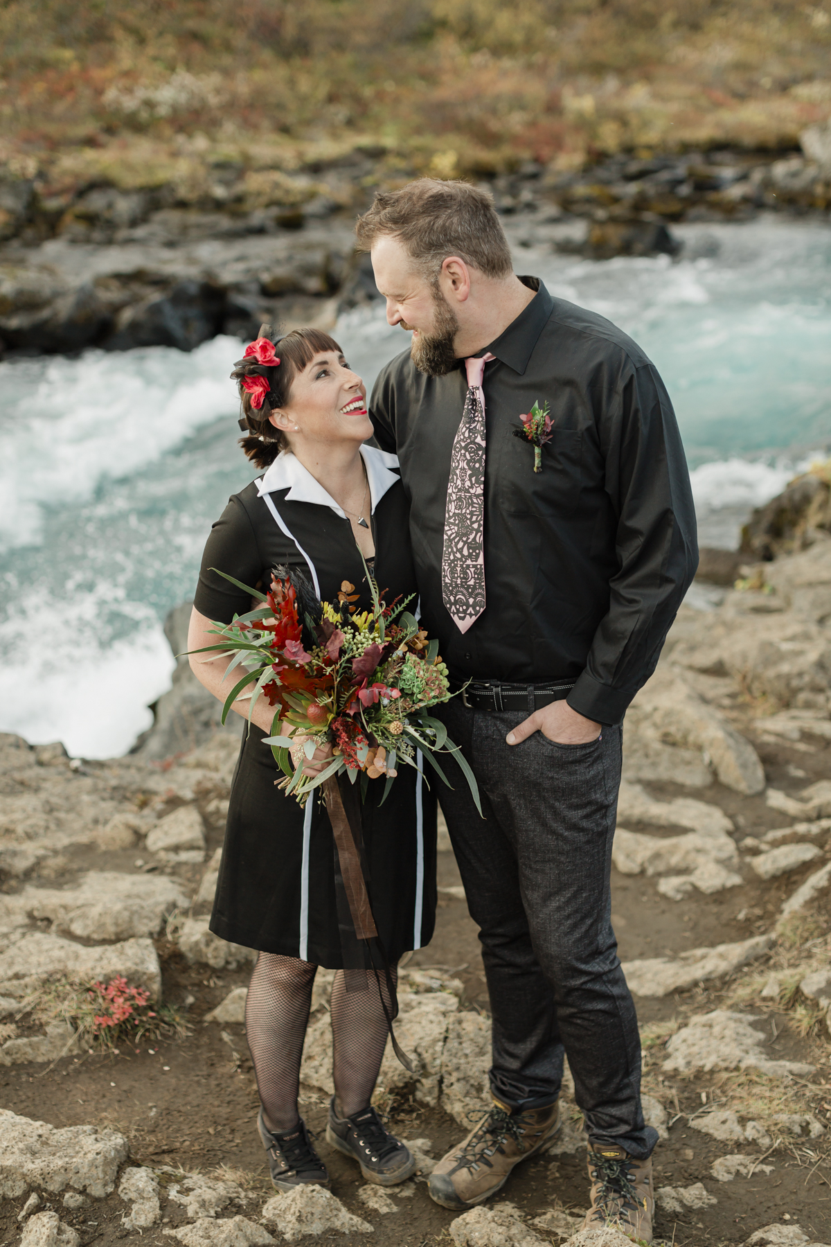 Elopement couple's portraits in front of a running waterfall in Iceland on the Golden Circle