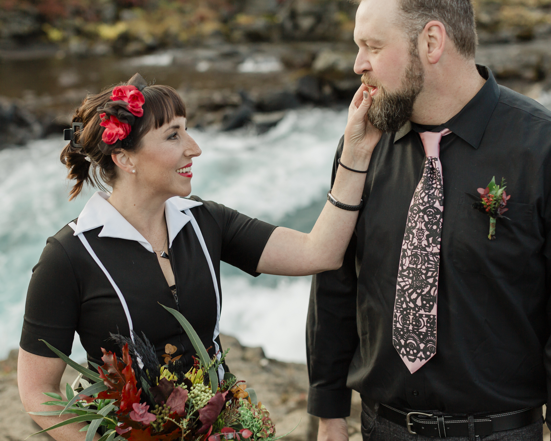 Elopement couple's portraits in front of a running waterfall in Iceland on the Golden Circle