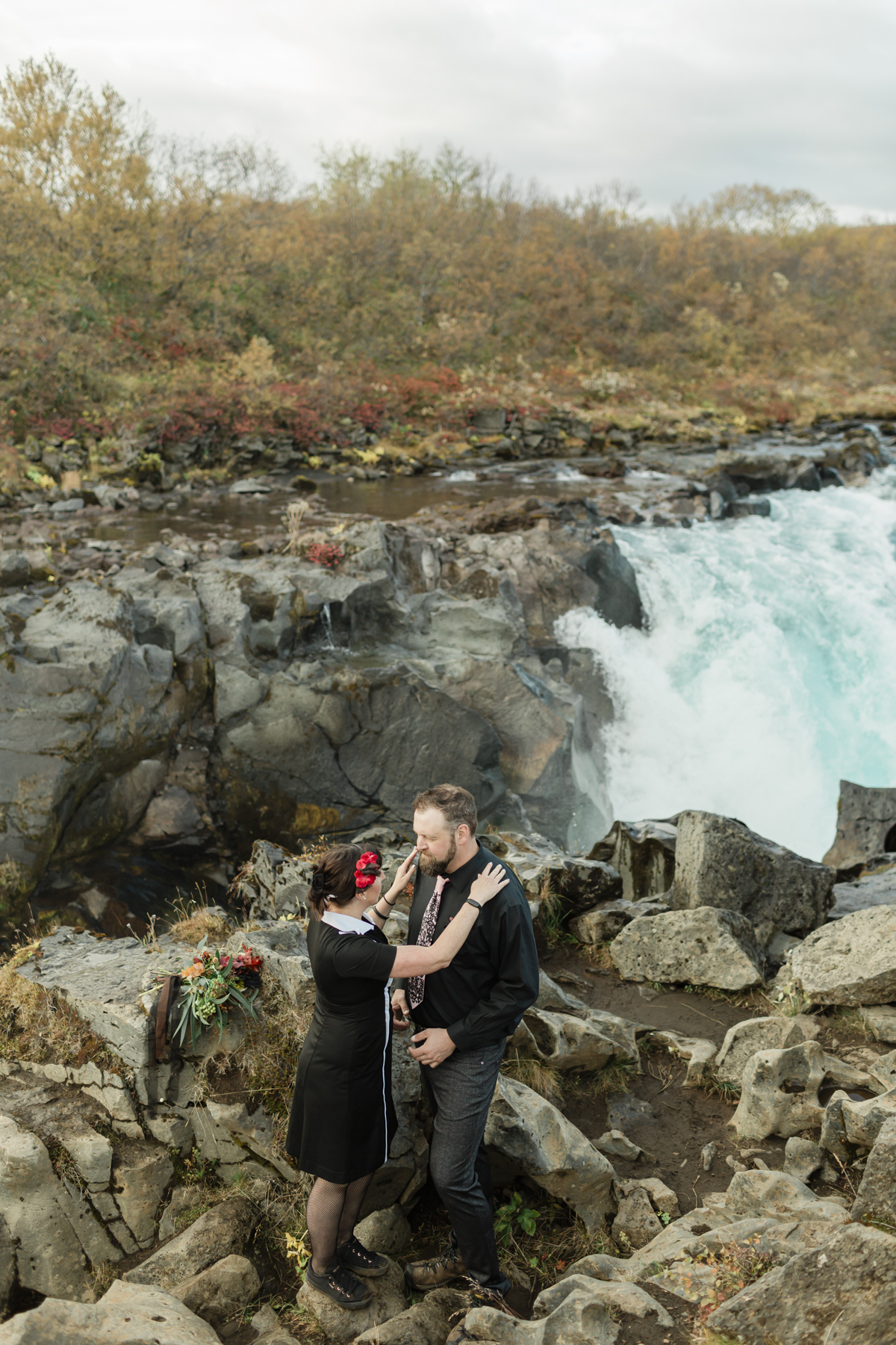 Virginia and Derek are about to have their elopement ceremony in front of a running waterfall in Iceland on the Golden Circle
