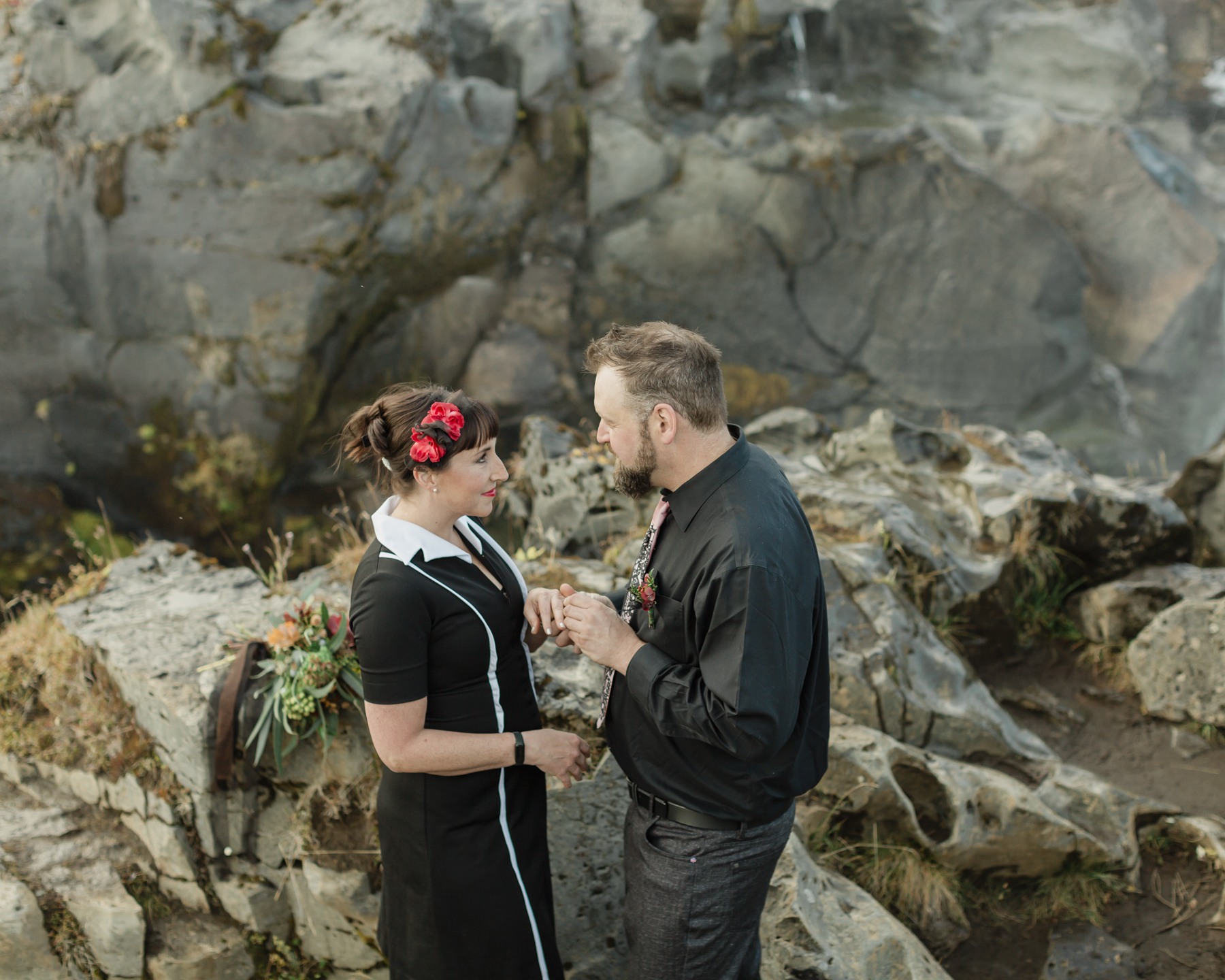 Virginia and Derek exchanging rings during their elopement ceremony in front of a running waterfall in Iceland on the Golden Circle