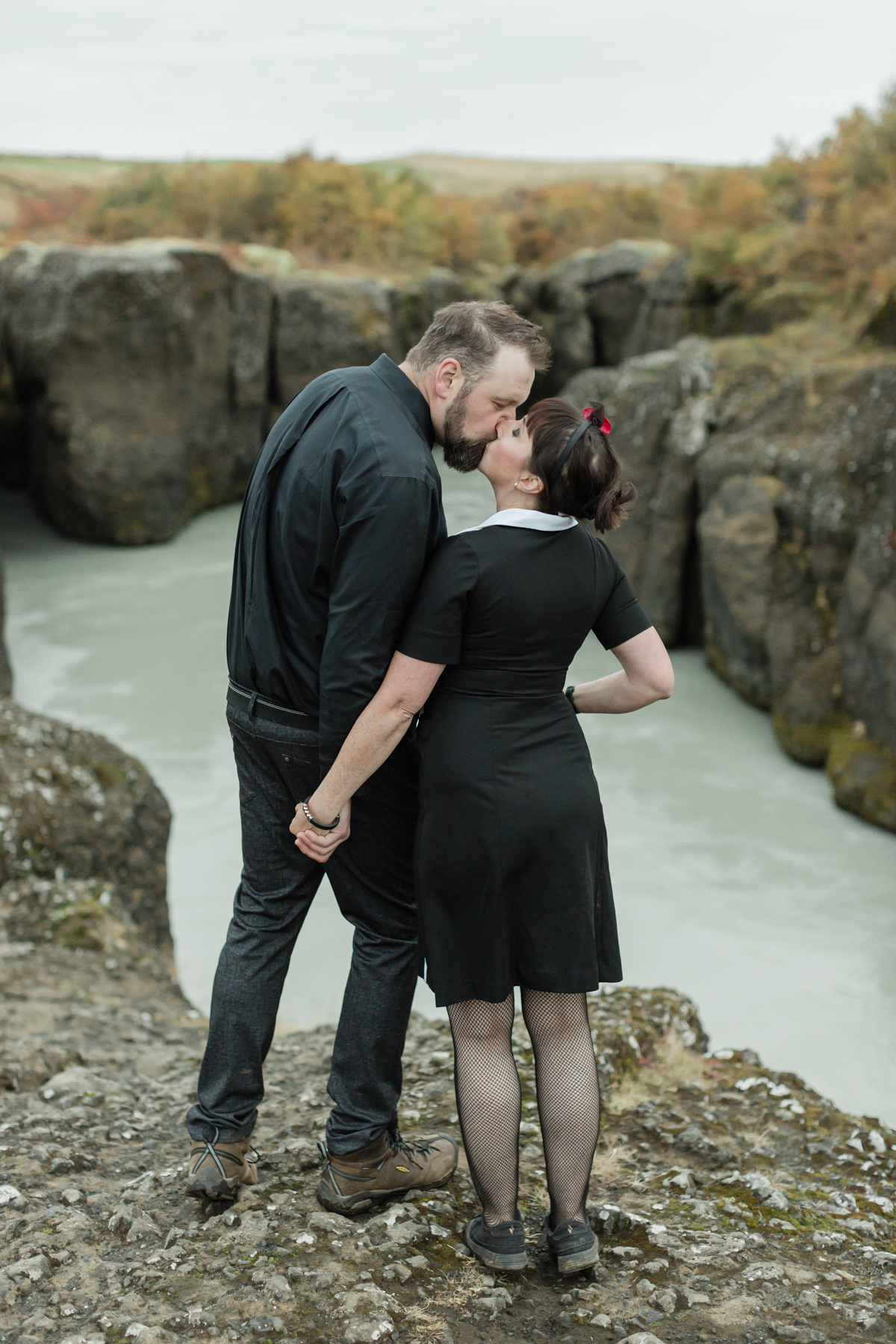 Virginia and Derek kissing in front of a canyon in the Golden Circle