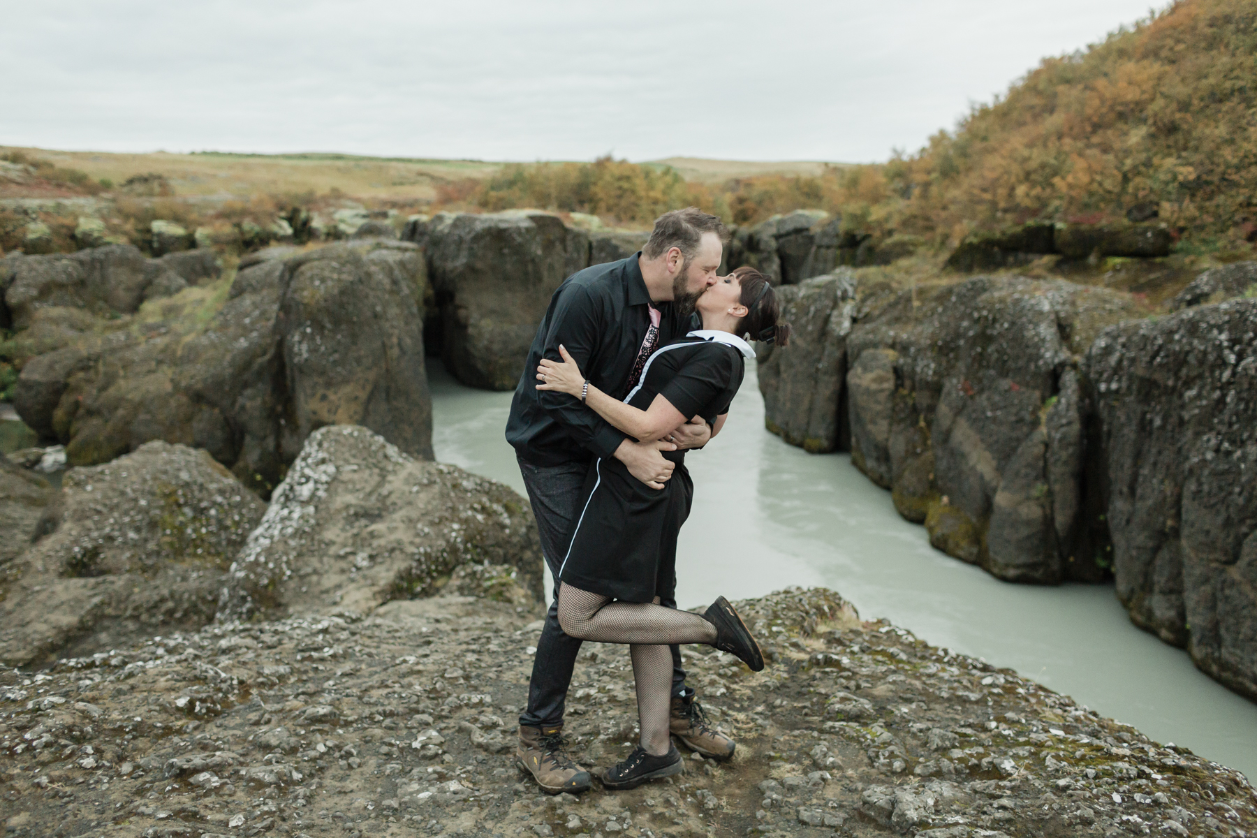 Virginia and Derek kissing in front of a canyon in the Golden Circle