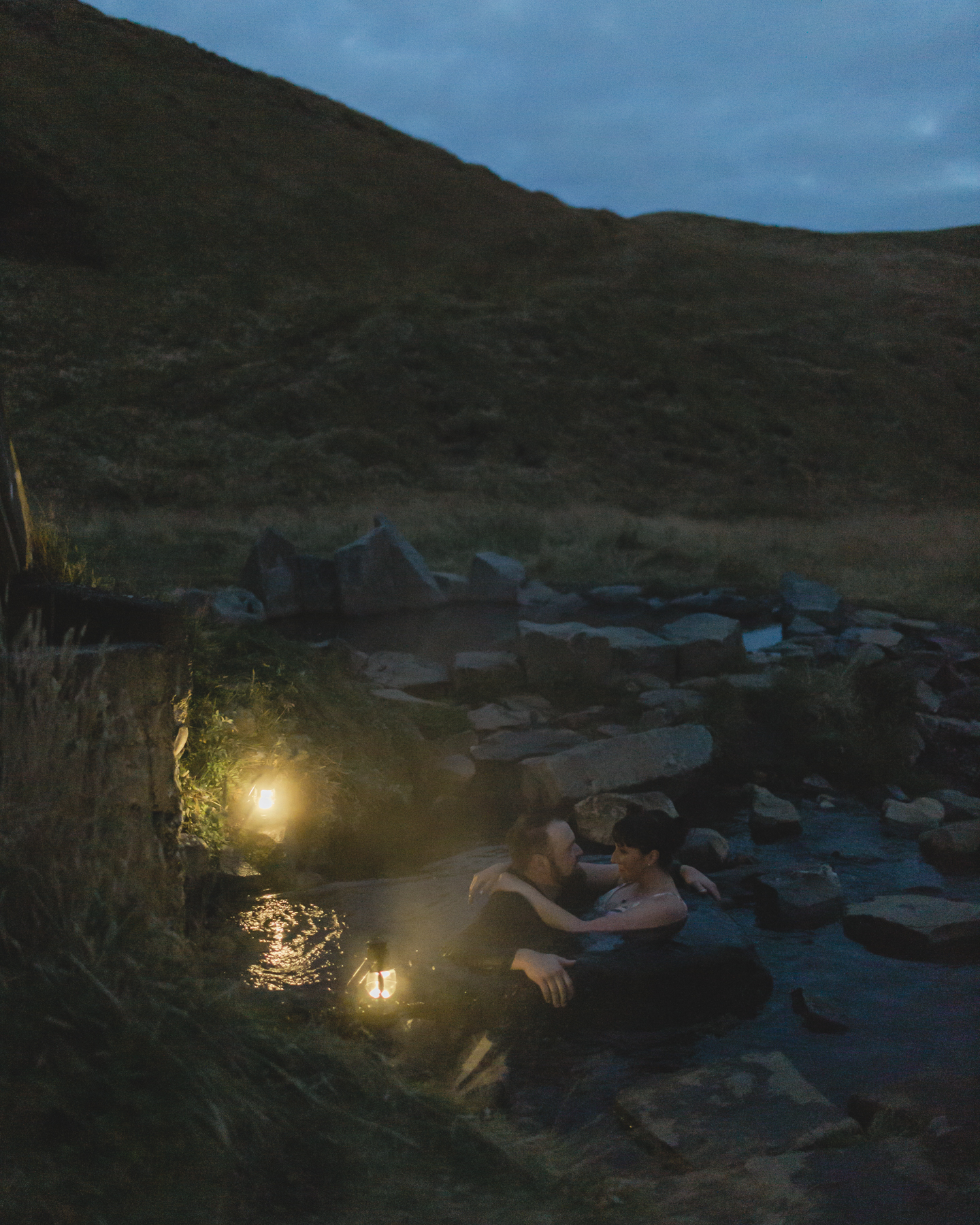 Virginia and Derek swimming in a lovers embrace at a hot spring in the Golden Circle