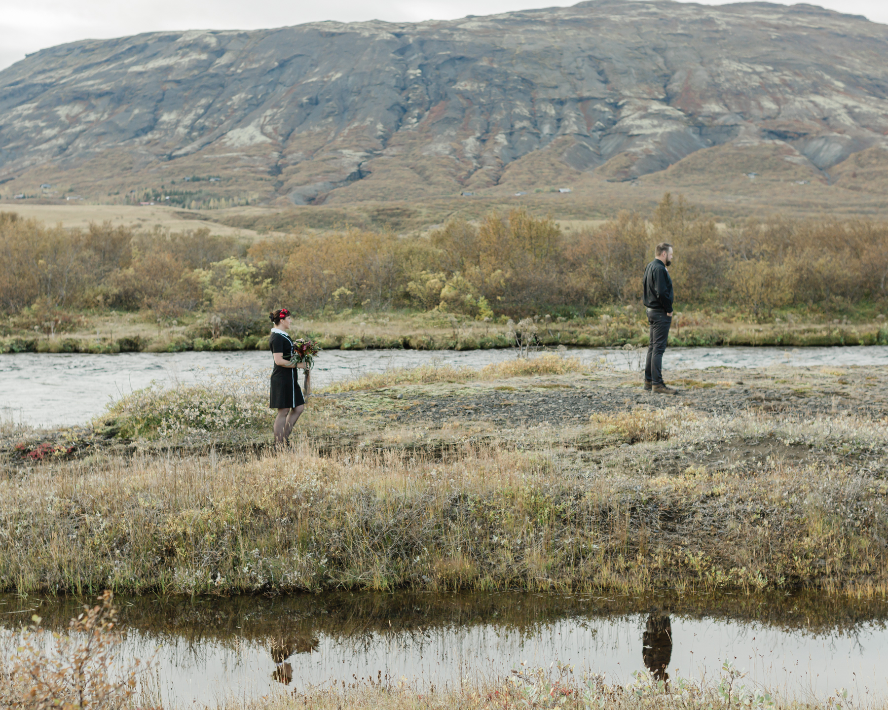 Before their Iceland elopement, Virginia and Derek are having their first look in front of a mountain in the Golden Circle