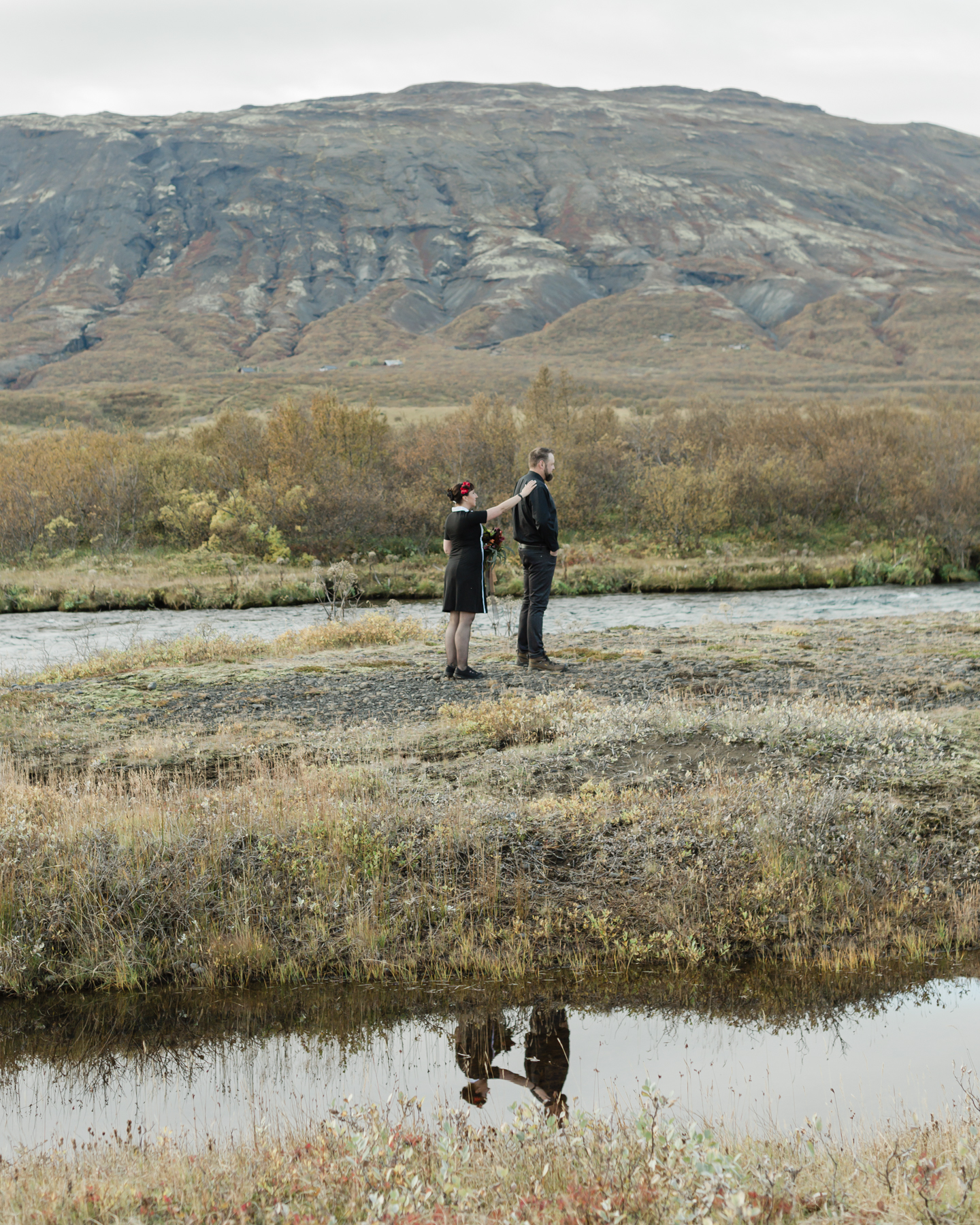 Before their Iceland elopement, Virginia and Derek are having their first look in front of a mountain in the Golden Circle