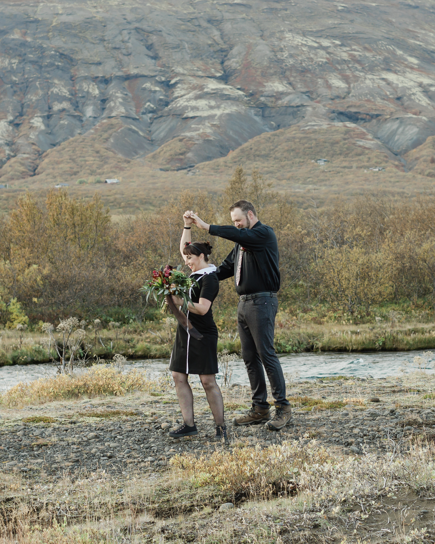 Before their Iceland elopement, Virginia and Derek are having their first look in front of a mountain in the Golden Circle