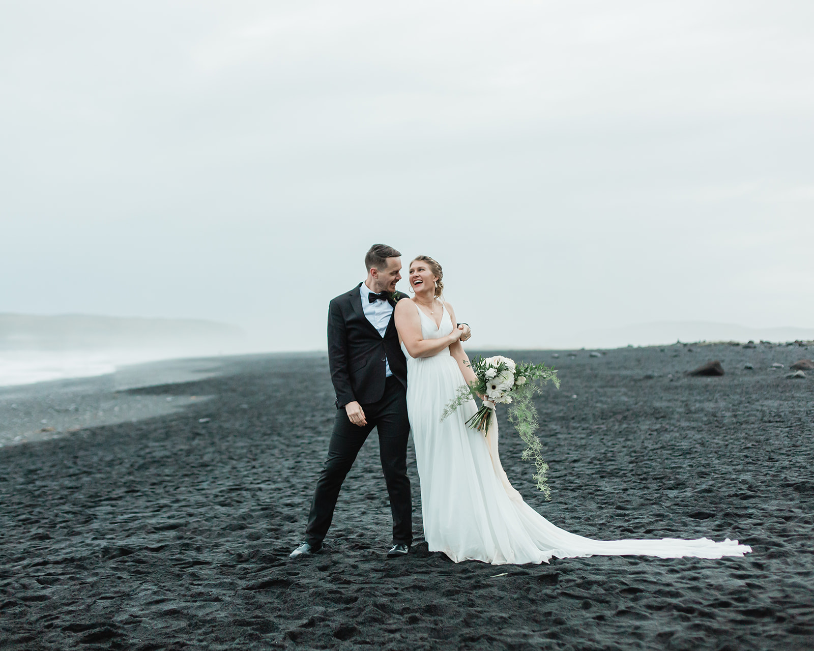 Nicole and michael dance on black sand beach