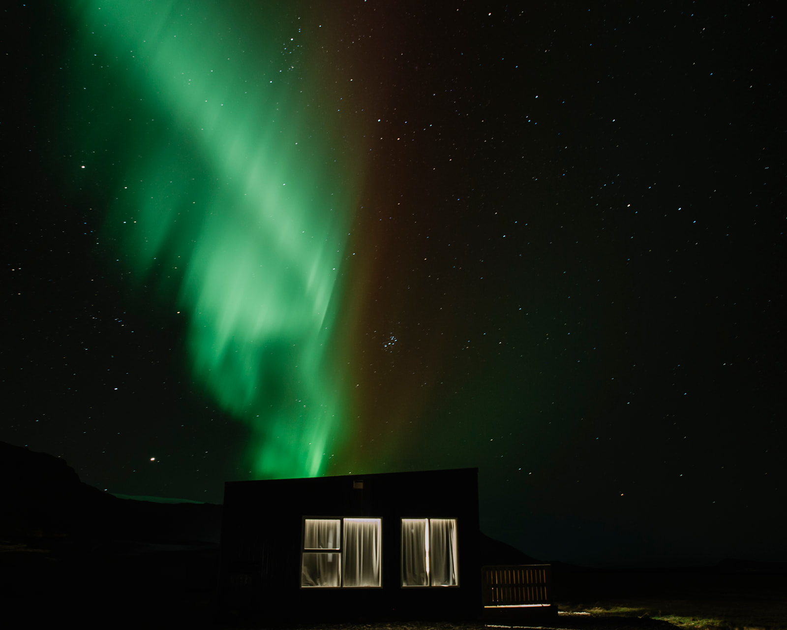 Aurora borealis in iceland above a cabin