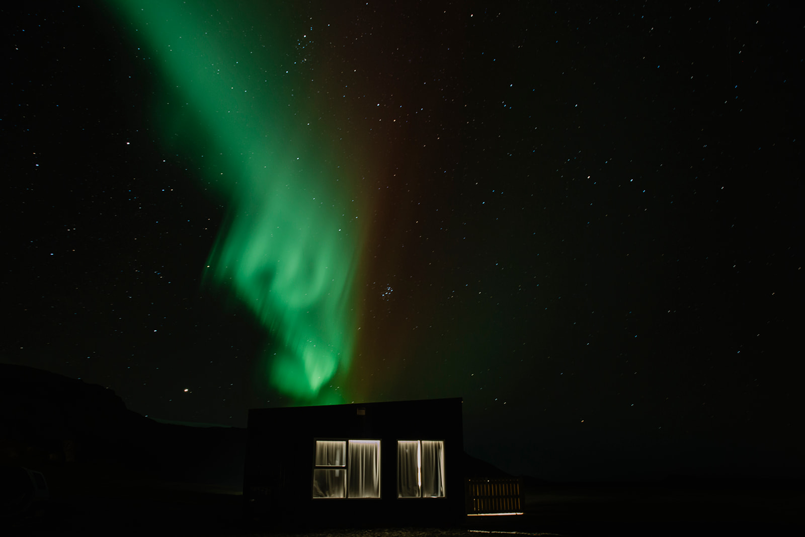 Northern Lights above a cabin during an Iceland elopement