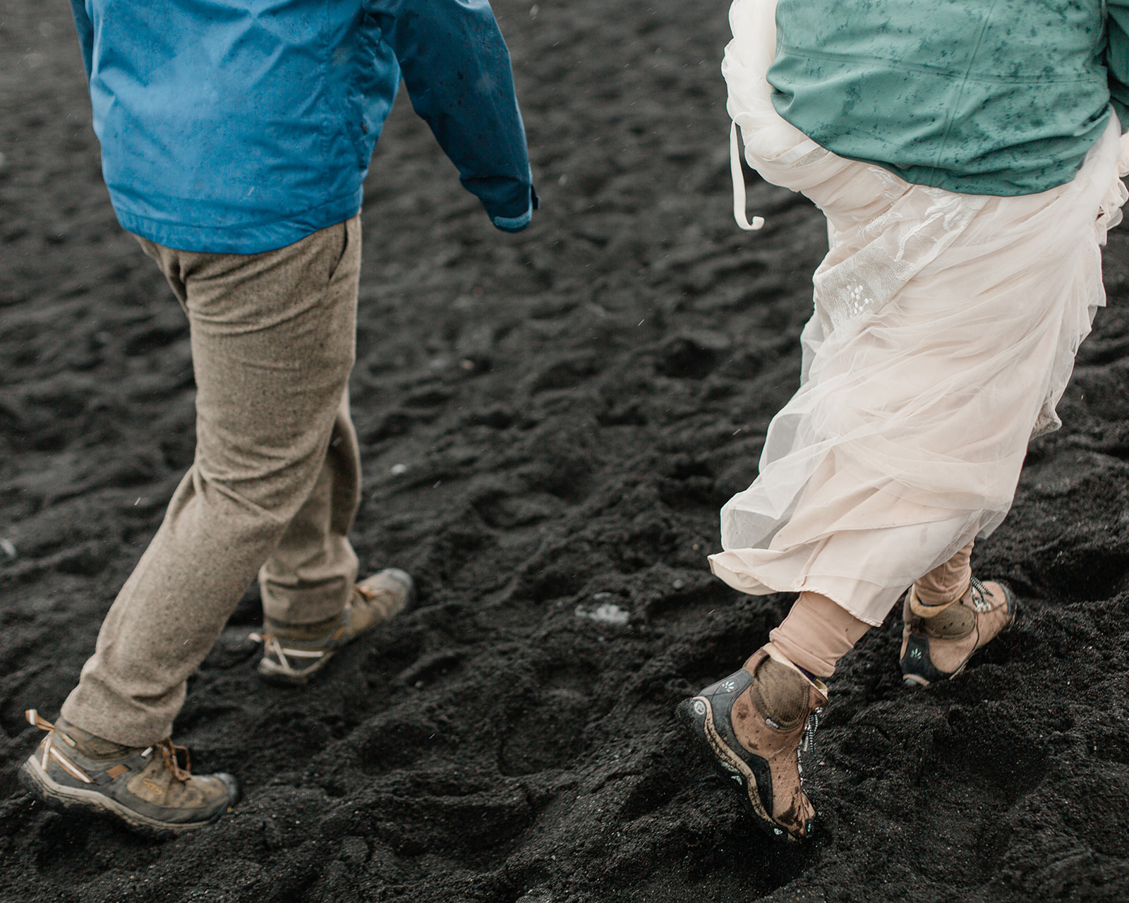 Leah and Darin walk in rain gear during their elopement