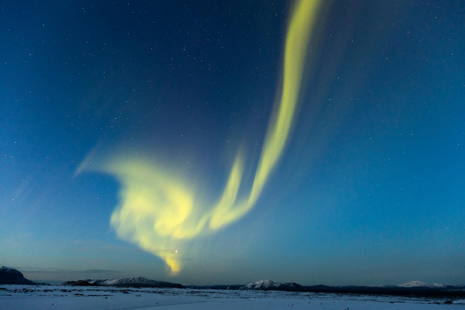 Yellow Aurora Borealis in twilight sky