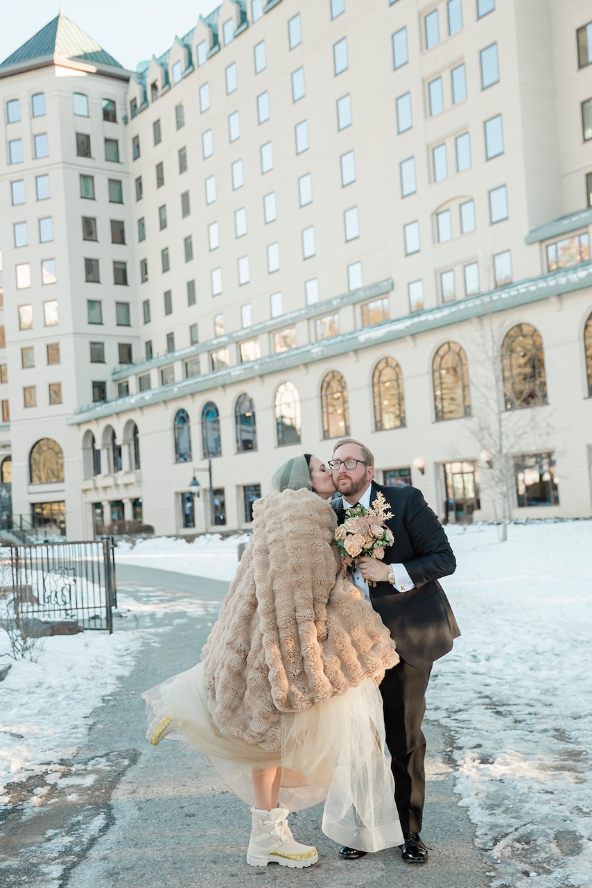 kirby and jonathan stand in front of a luxury hotel
