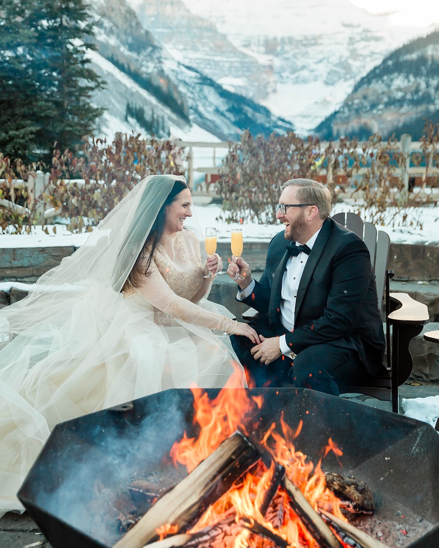 Kirby + Jonathan sipping mimosas fireside during their banff elopement