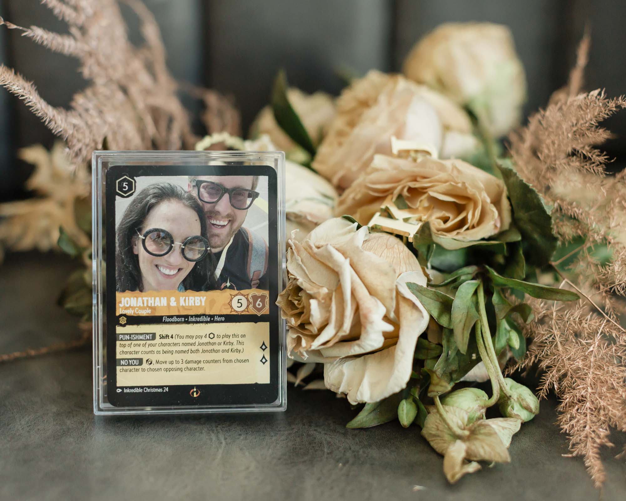 Custom Lorcana card deck and florals featured together for an accessory and detail photo