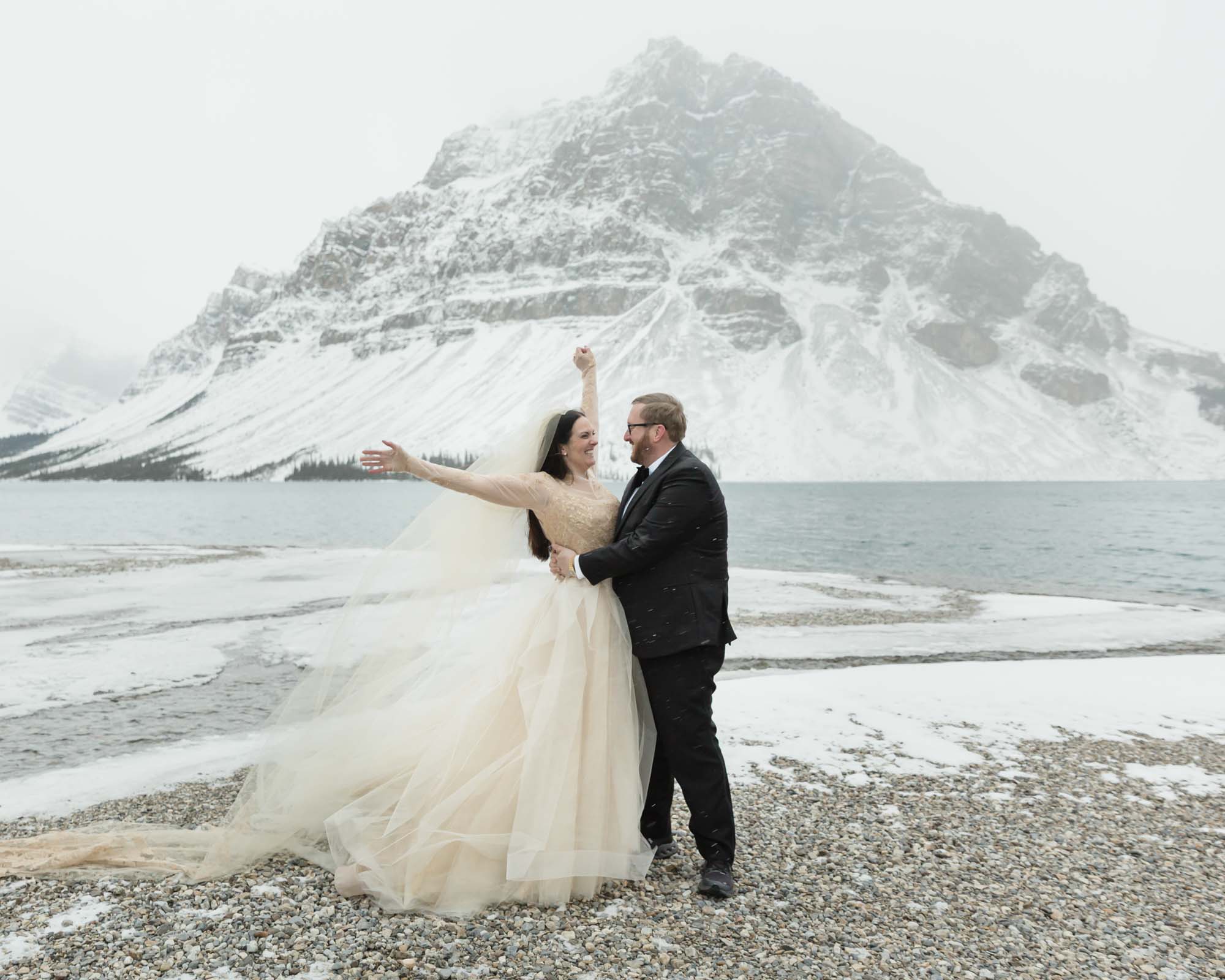 Wedding couple posing at Bow Lake in Banff National Park during their Elopement