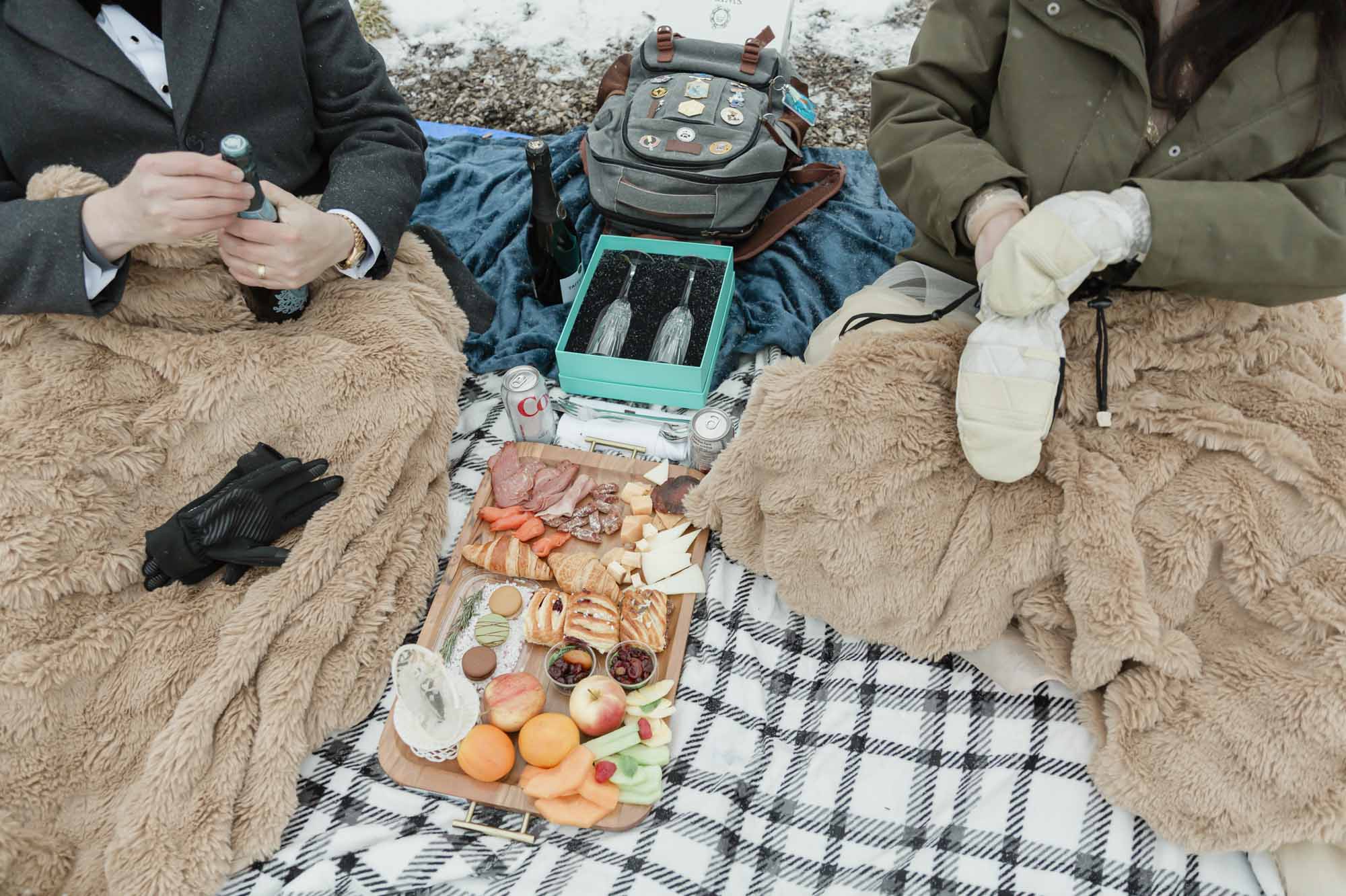 Wedding couple enjoying a winter picnic at Bow Lake in Banff National Park during their Elopement