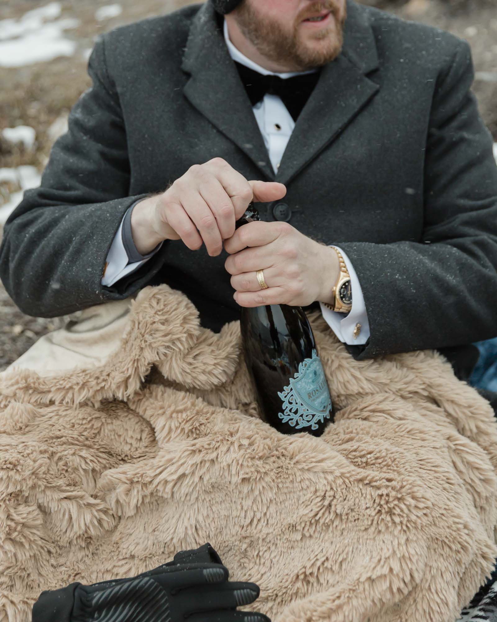 Wedding couple enjoying a winter picnic at Bow Lake in Banff National Park during their Elopement