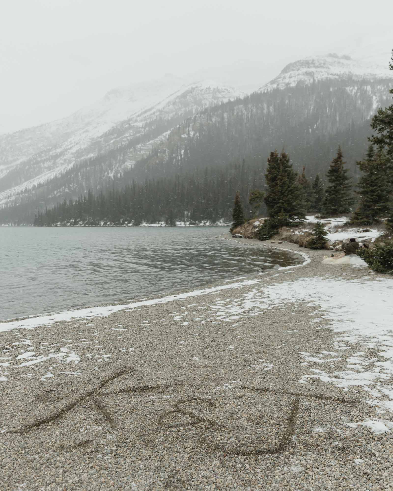 K and J in the sand in front of the mountains