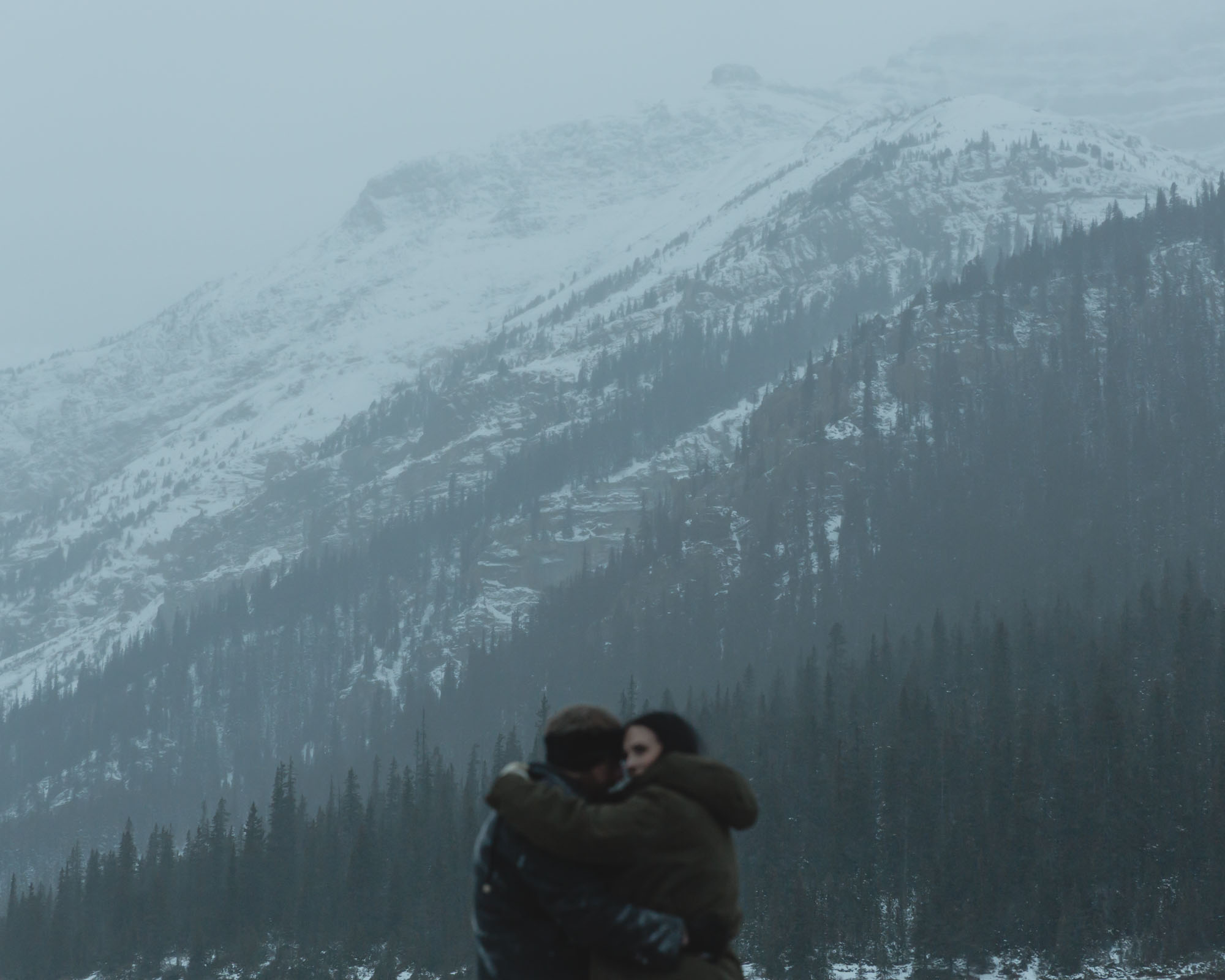 Wedding couple having their first dance at Bow Lake in Banff National Park during their Elopement in the winter at sunset