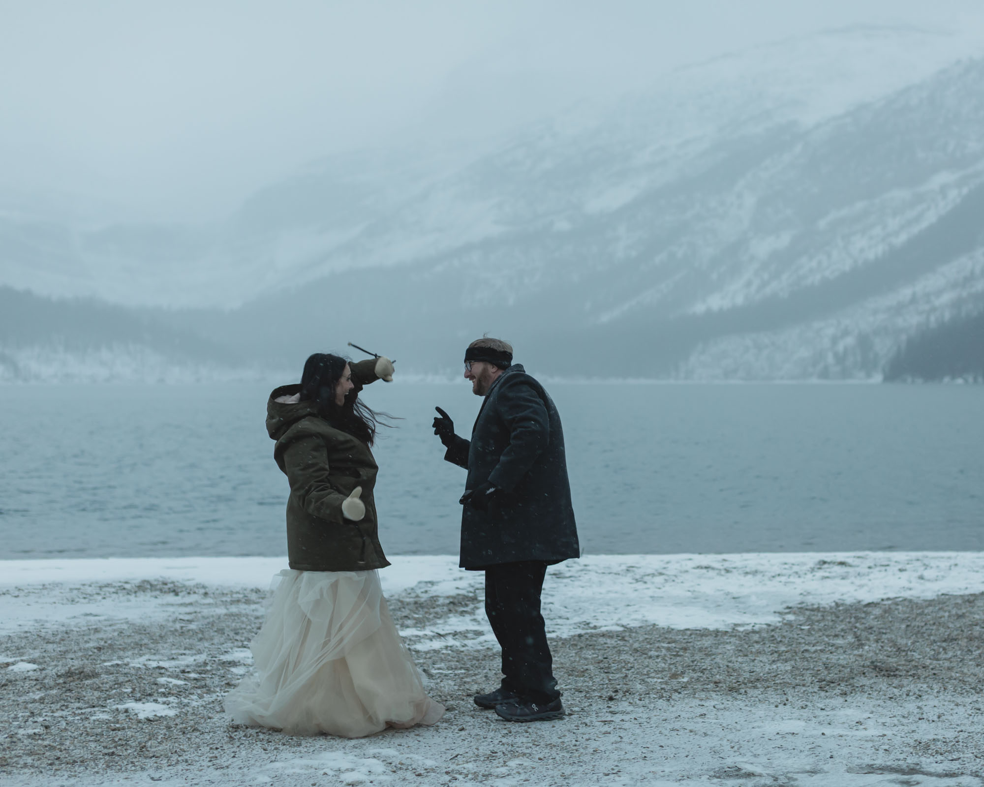 Wedding couple having their first dance at Bow Lake in Banff National Park during their Elopement in the winter at sunset