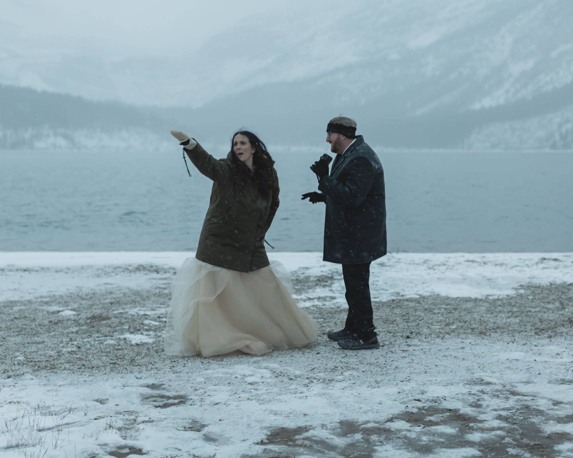 Wedding couple having their first dance at Bow Lake in Banff National Park during their Elopement in the winter at sunset