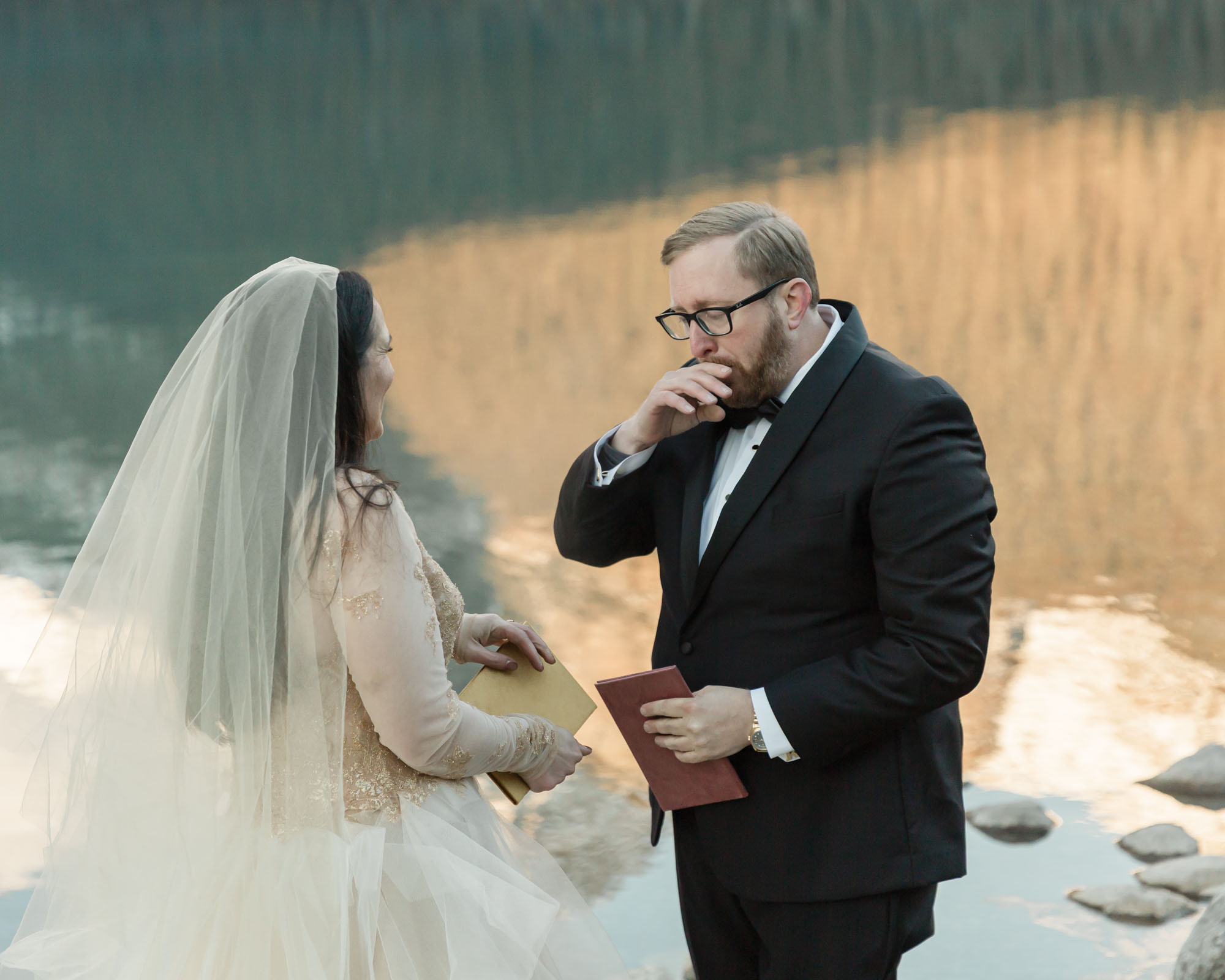 A Lake louise elopement, the couple is saying their vows and the bride is emotional