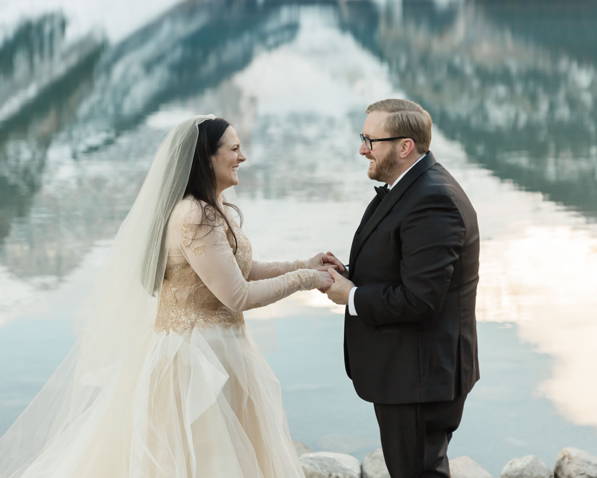 A Lake Louise elopement, the couple is exchanging their wedding rings