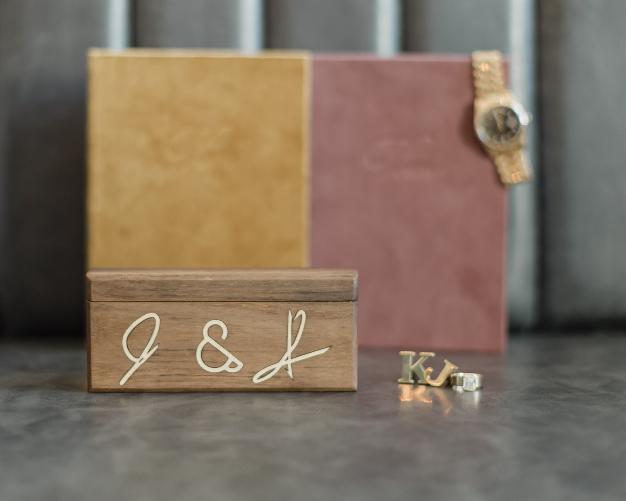 Vow books, wedding rings, cufflinks, ring box and the groom's watch featured together for an accessory and detail photo