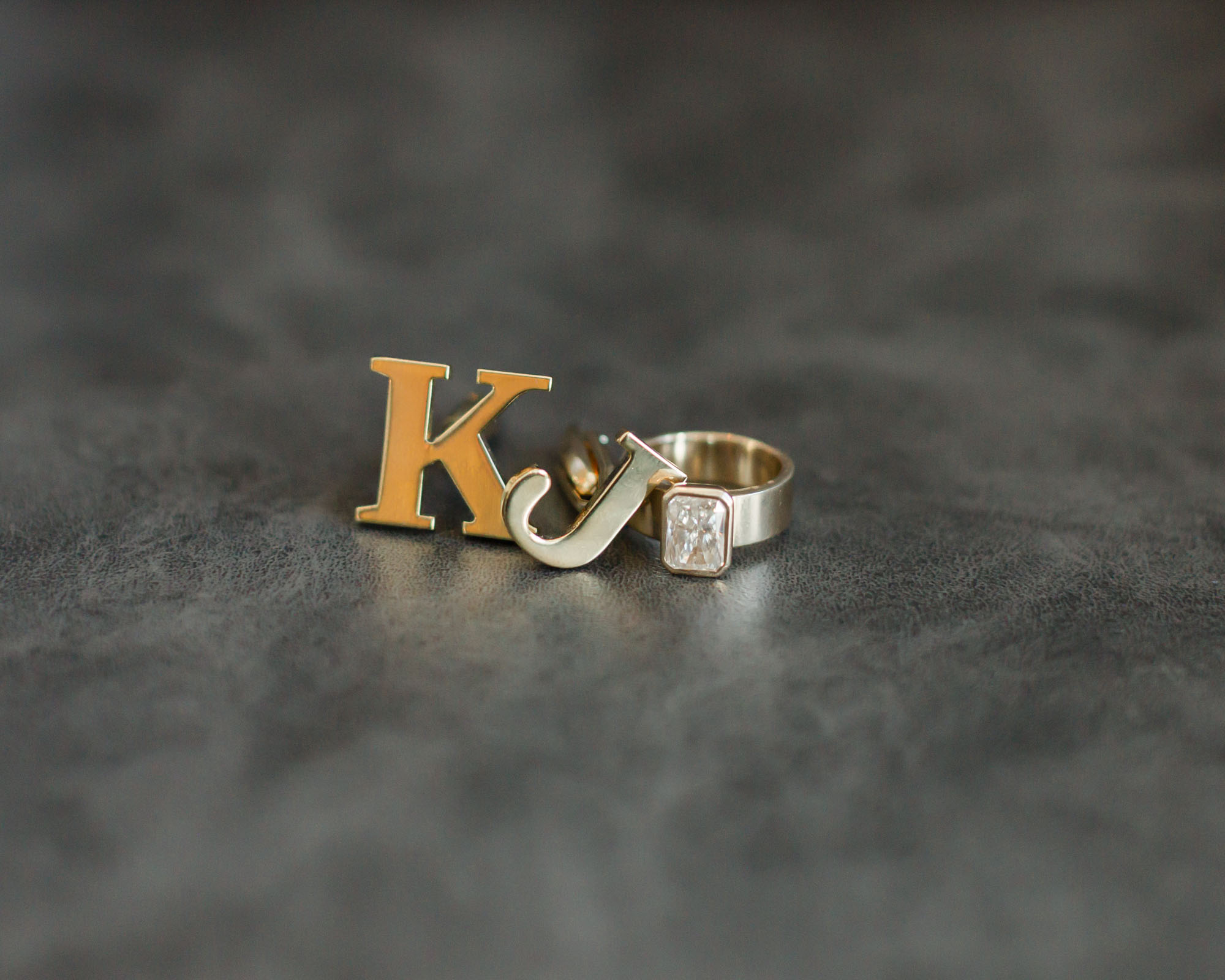 Vow books, wedding rings, cufflinks, ring box and the groom's watch featured together for an accessory and detail photo