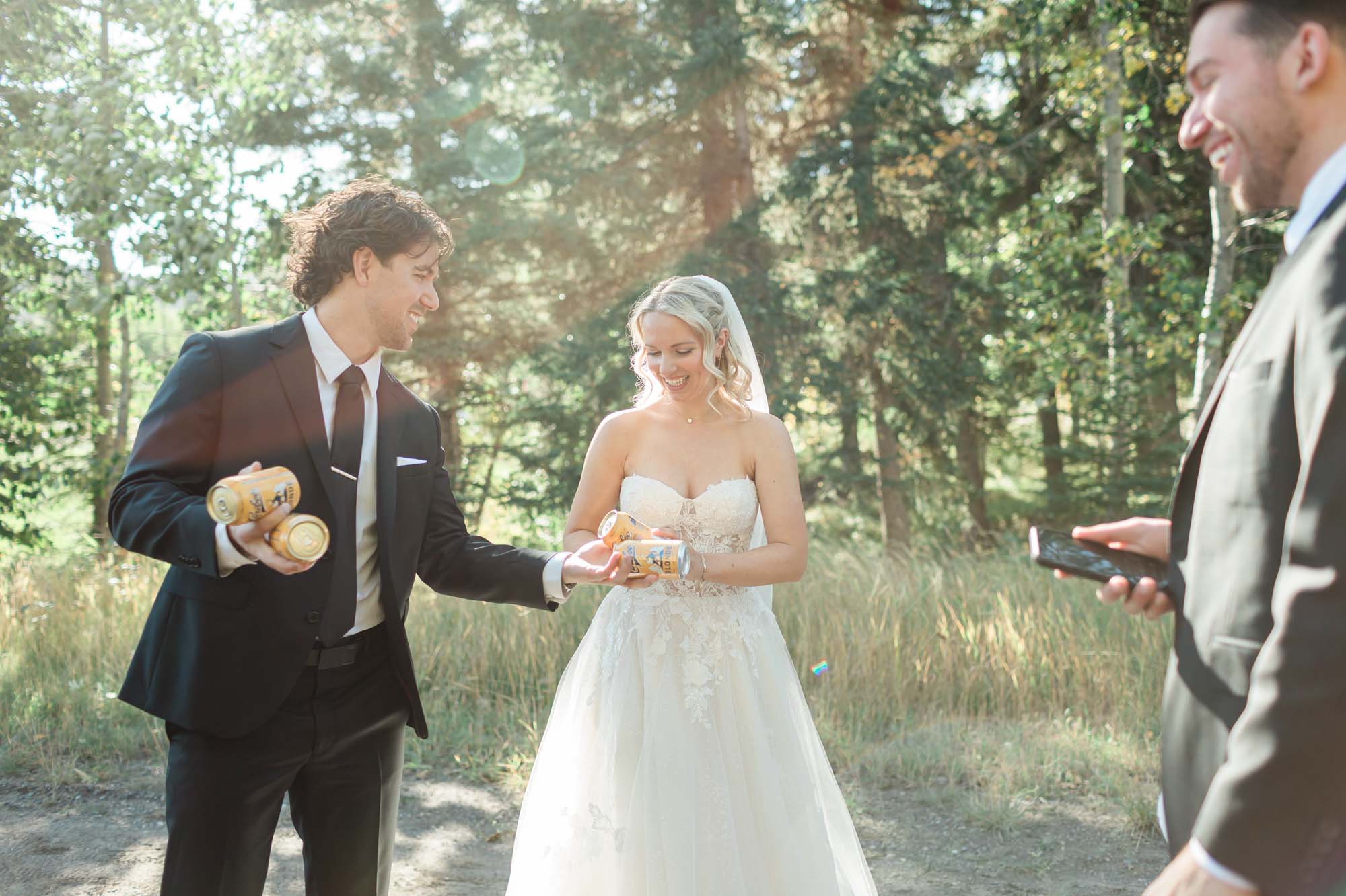 tyler and sara sharing a beer after their first look during their summer elopement in banff