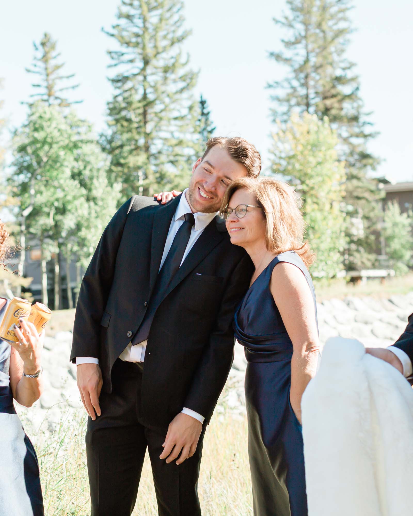 tyler's brother and mother hugging while celebrating the bride and groom